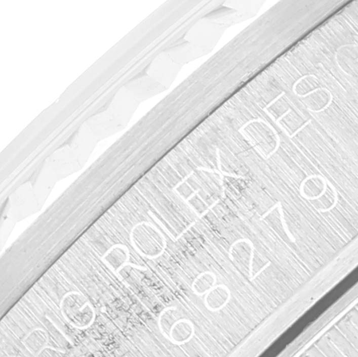 This close-up image shows the engraved side of a Rolex President 68279 Women's Stainless Steel Silver Dial 68279 Women's Stainless Steel Silver Dial model watch case, including part of the fluted bezel.