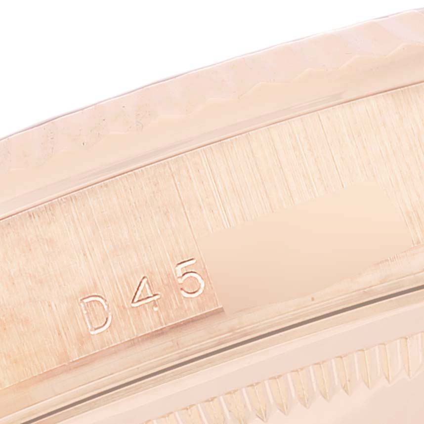 The image shows a close-up of the case edge, including the serial number, of the Rolex President 118235 Men's Rose Gold Pink Dial 118235 Men's Rose Gold Pink Dial model watch.