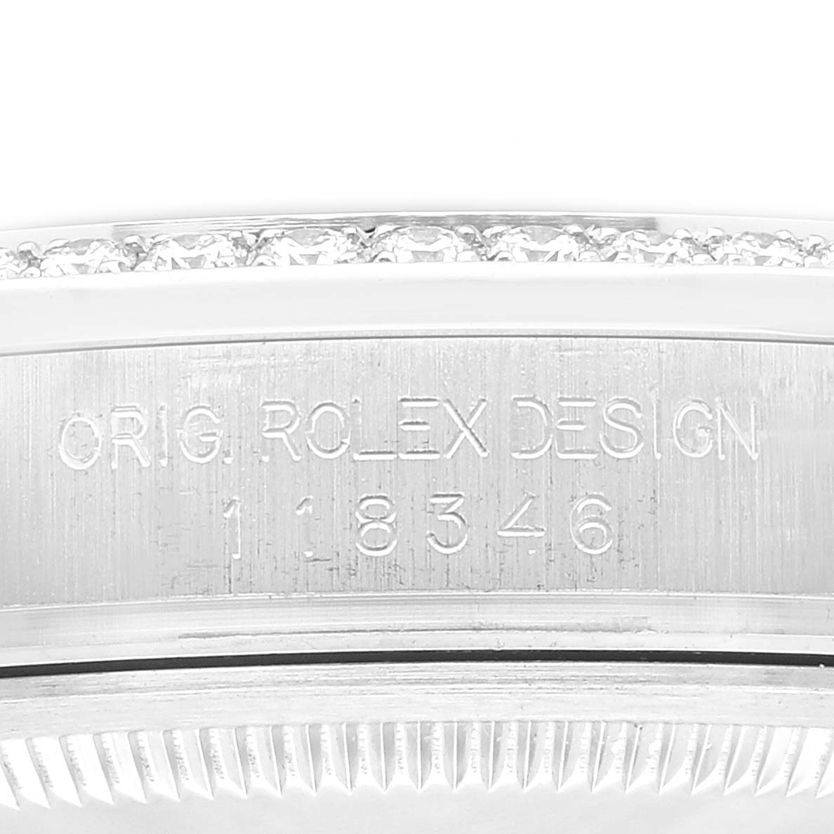 This image shows the side view of the bezel and case with the "ORIG. ROLEX DESIGN" engraving from a Rolex President 118346 Men's White Gold Blue Dial 118346 Men's White Gold Blue Dial model watch.