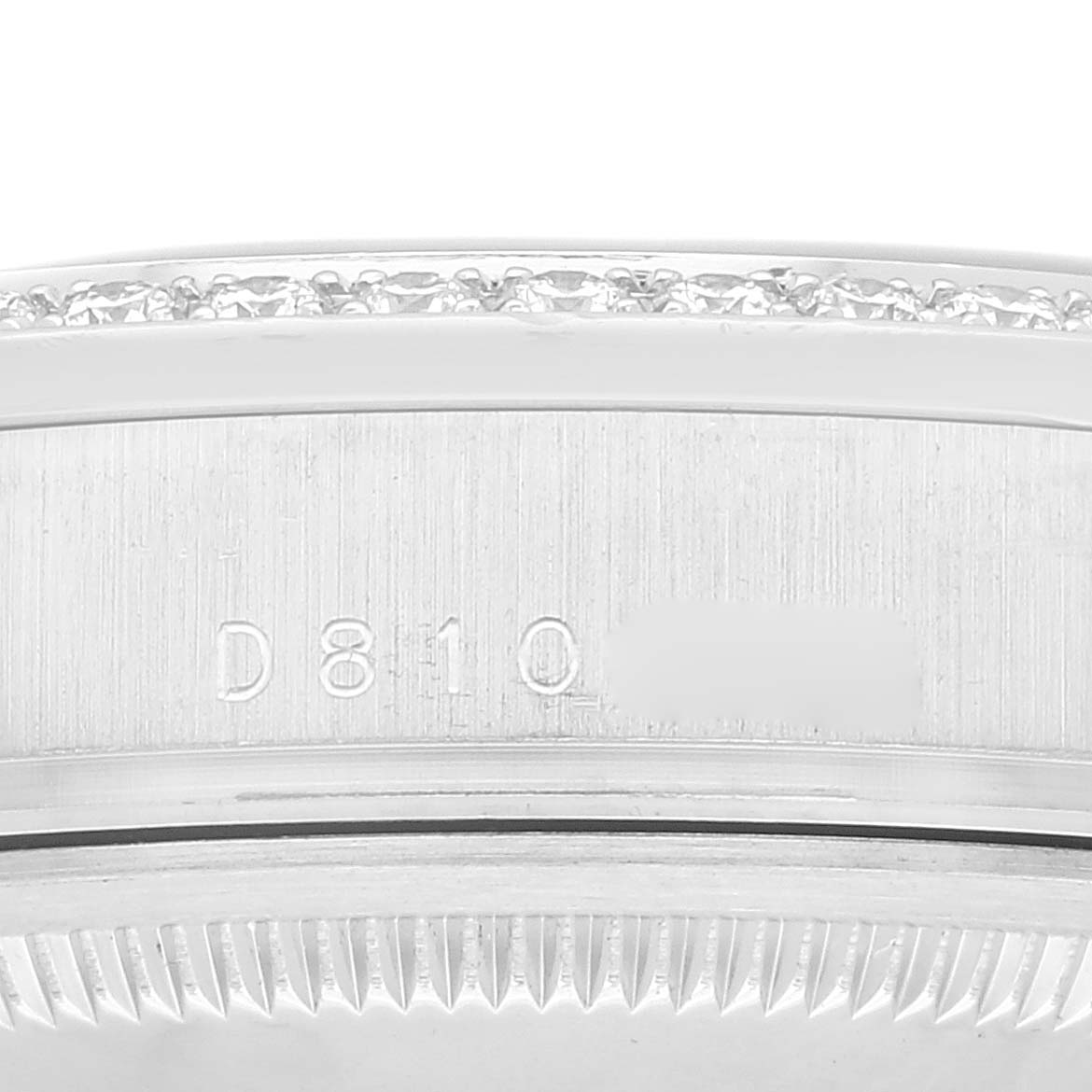 This image shows a close-up of the serial number and bezel of a President model Rolex watch.