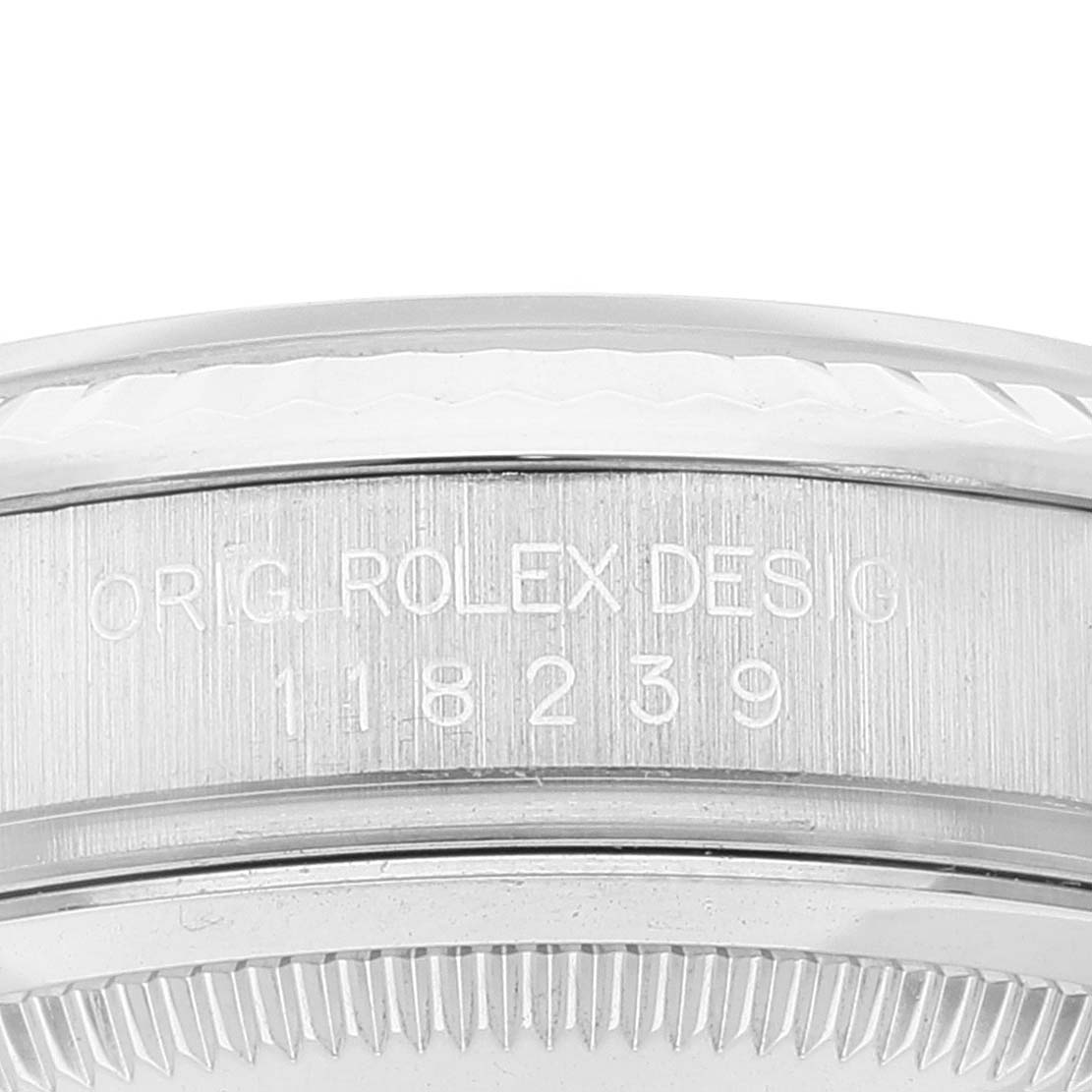 This image shows a close-up of the side of a Rolex President 118239 Men's Stainless Steel Silver Dial 118239 Men's Stainless Steel Silver Dial model watch, highlighting its engraved serial number.