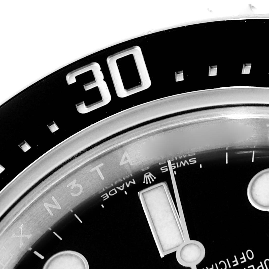 Close-up angle of the Rolex Sea-Dweller 126600 Men
s Stainless Steel Black Dial 126600 Men
s Stainless Steel Black Dial watch showing part of the bezel, dial, and hour markers.