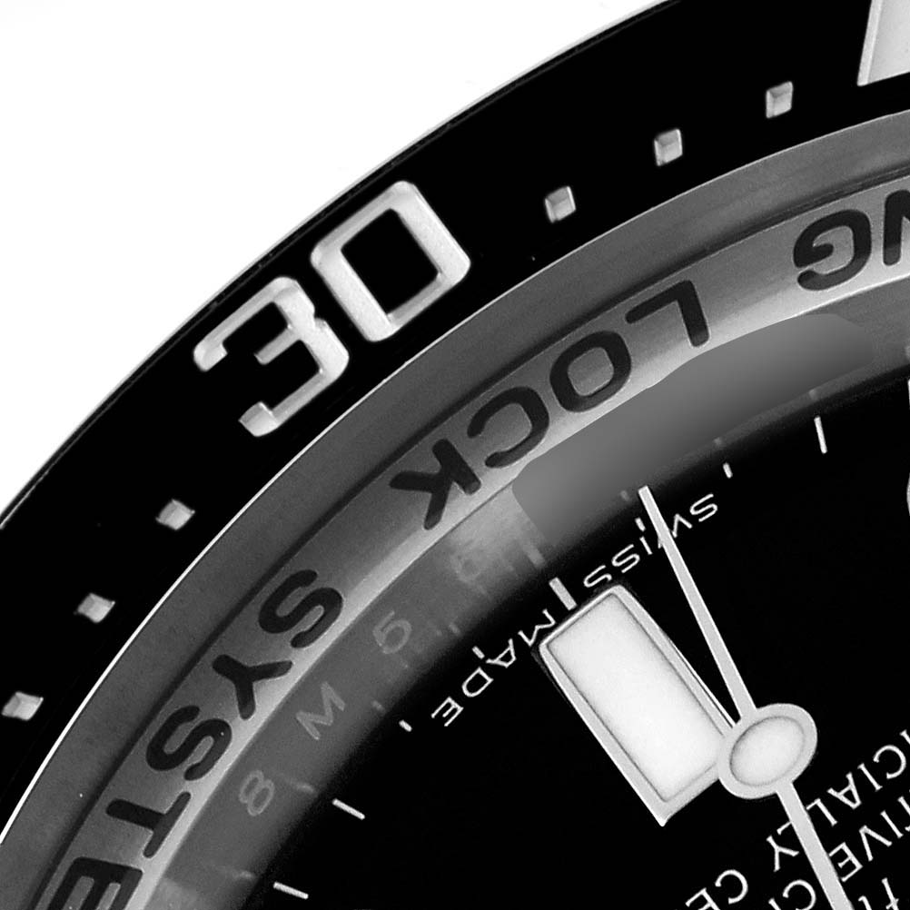 The image shows a close-up of the bezel, dial, and a part of the hand of the Rolex Sea-Dweller 116660 Men
s Stainless Steel Black Dial 116660 Men
s Stainless Steel Black Dial watch at an oblique angle.