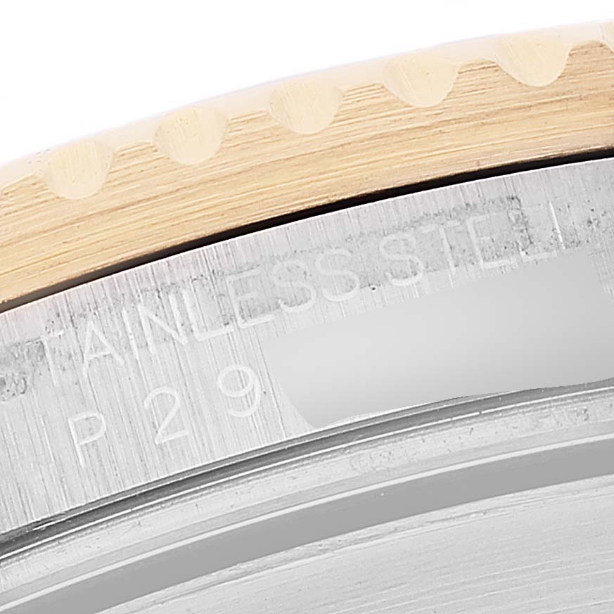 This image shows a close-up of the side of a Rolex Submariner 16613 Men's Steel and Gold (two tone) Blue Dial 16613 Men's Steel and Gold (two tone) Blue Dial watch case, highlighting the stainless steel material and engravings.