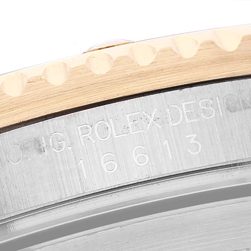This image shows a close-up of the side edge of a Rolex Submariner 16613 Men's Steel and Gold (two tone) Blue Dial 16613 Men's Steel and Gold (two tone) Blue Dial watch, including the engraved model number 16613.