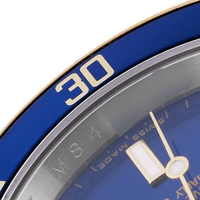 This is a close-up of the bezel and dial of a Rolex Submariner 16613 Men
s Steel and Gold (two tone) Blue Dial 16613 Men
s Steel and Gold (two tone) Blue Dial, showing the 30-minute mark.