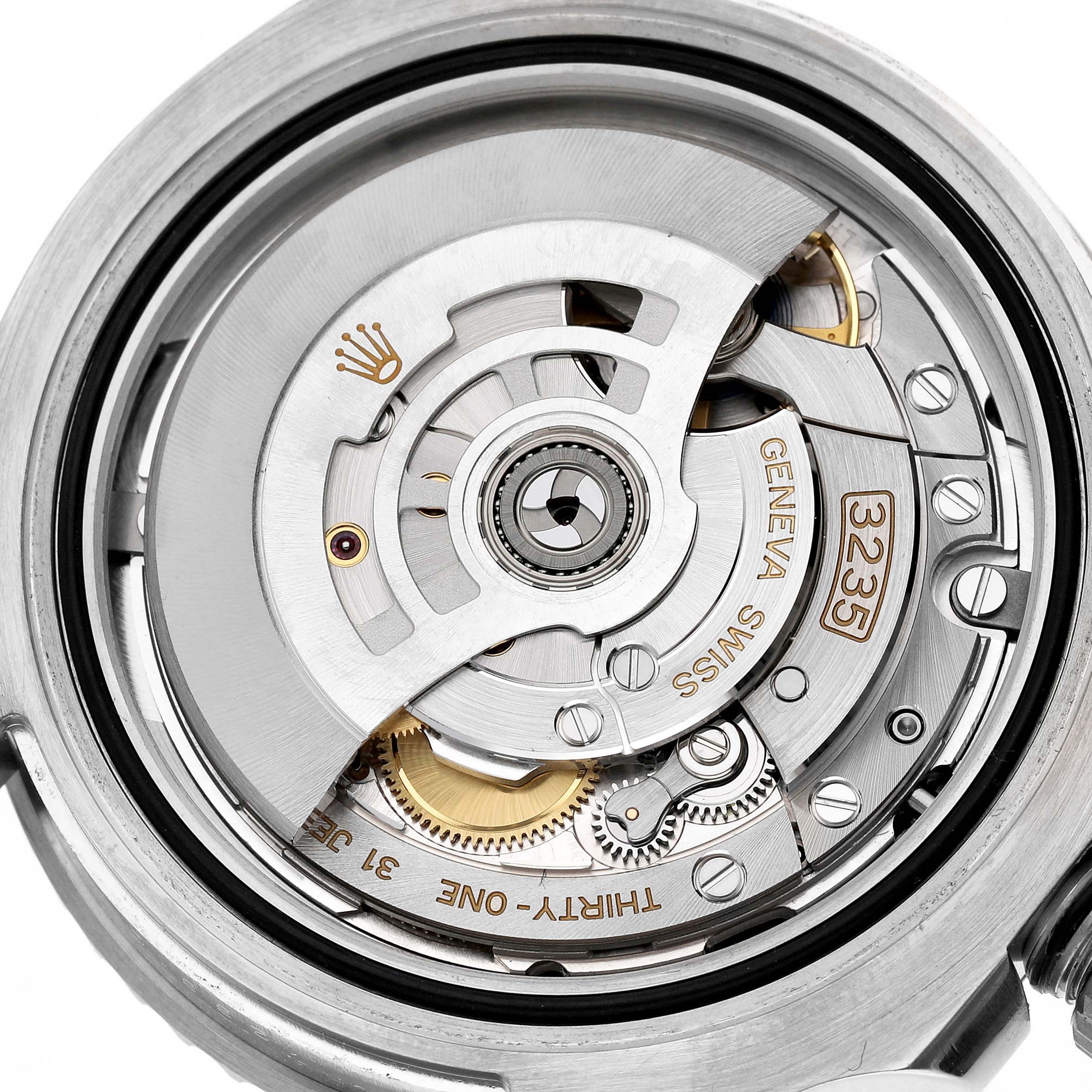 The image shows the movement of a Rolex Submariner 126610LN Men's Stainless Steel Black Dial, featuring gears and inscriptions viewed from the back.