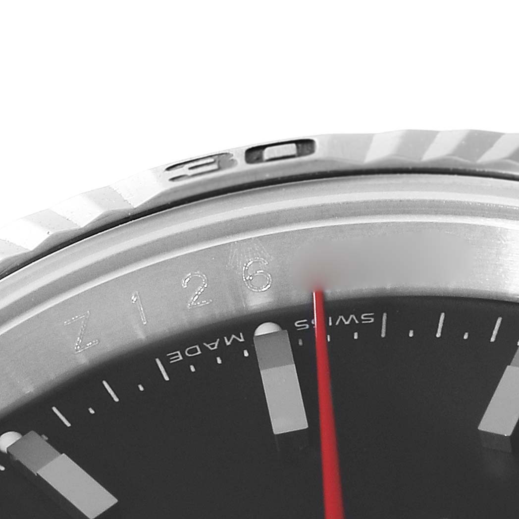 This close-up image shows the bezel and part of the dial with the red hand of a Rolex Turn-o-Graph 116264 Men's Stainless Steel Black Dial 116264 Men's Stainless Steel Black Dial watch.