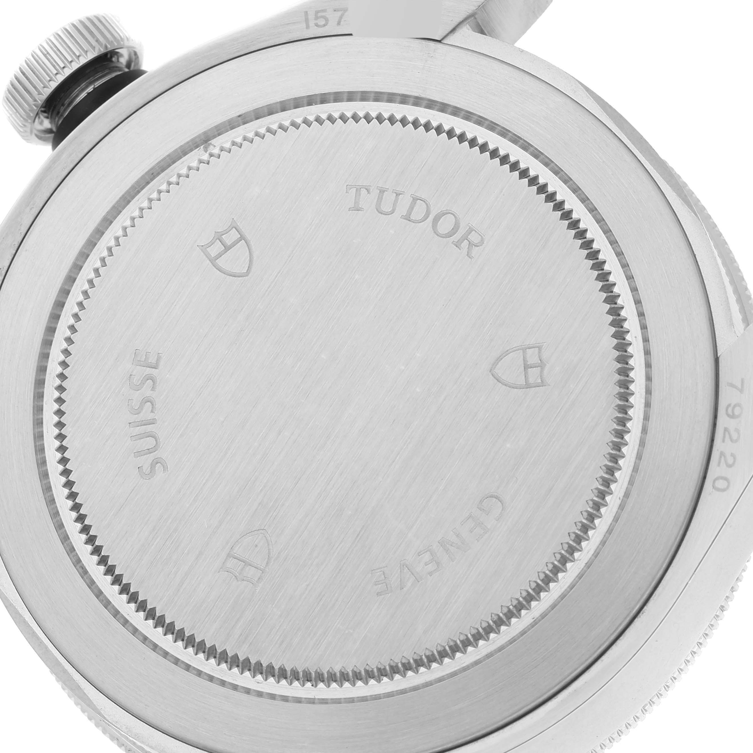 The image shows the back case of the Tudor Heritage Black Bay 79220 Men
s Stainless Steel Black Dial 79220 Men
s Stainless Steel Black Dial watch, featuring engraving and branding details.