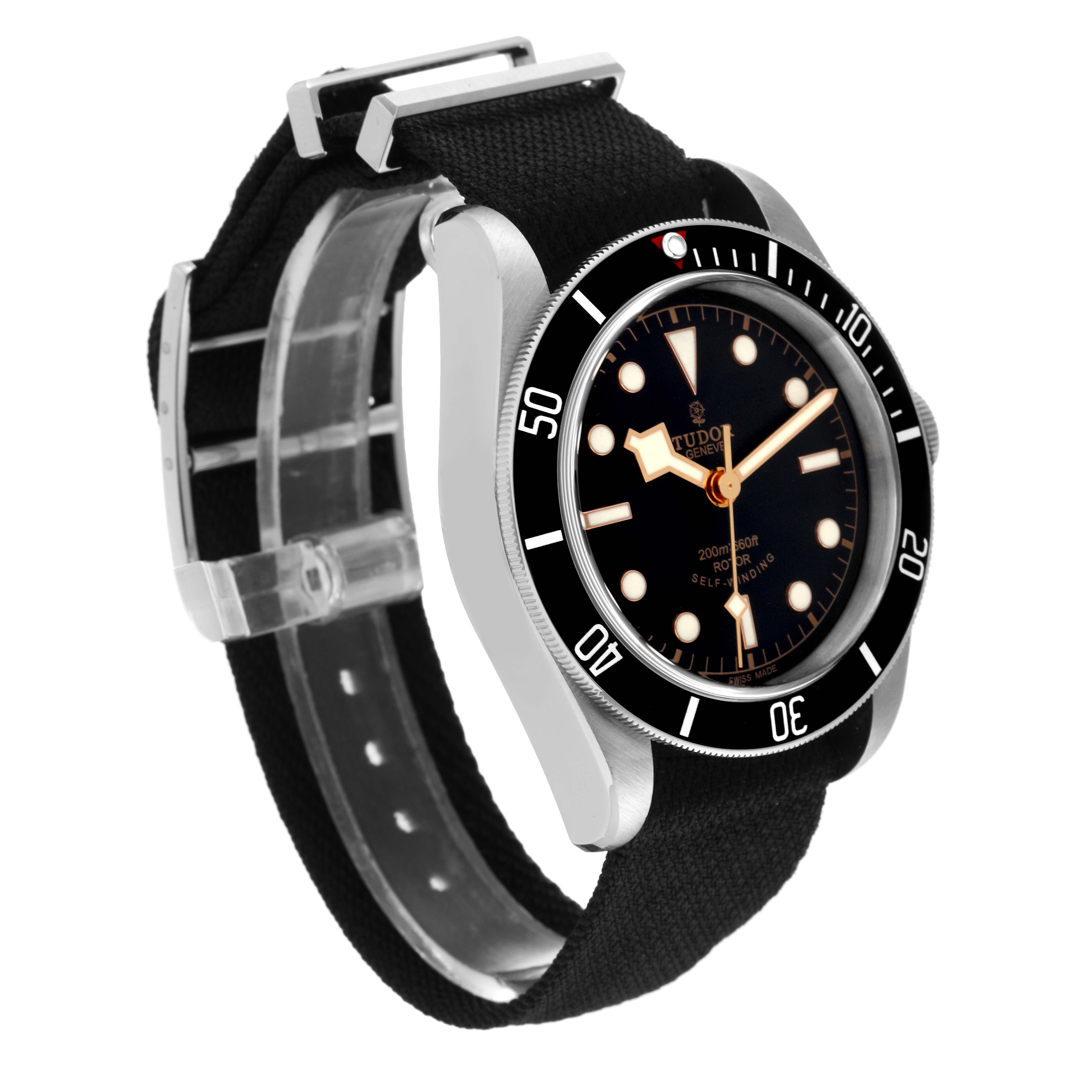 The image shows a front-side view of a Tudor Heritage Black Bay 79220 Men
s Stainless Steel Black Dial 79220 Men
s Stainless Steel Black Dial watch, featuring the dial, bezel, and fabric strap.