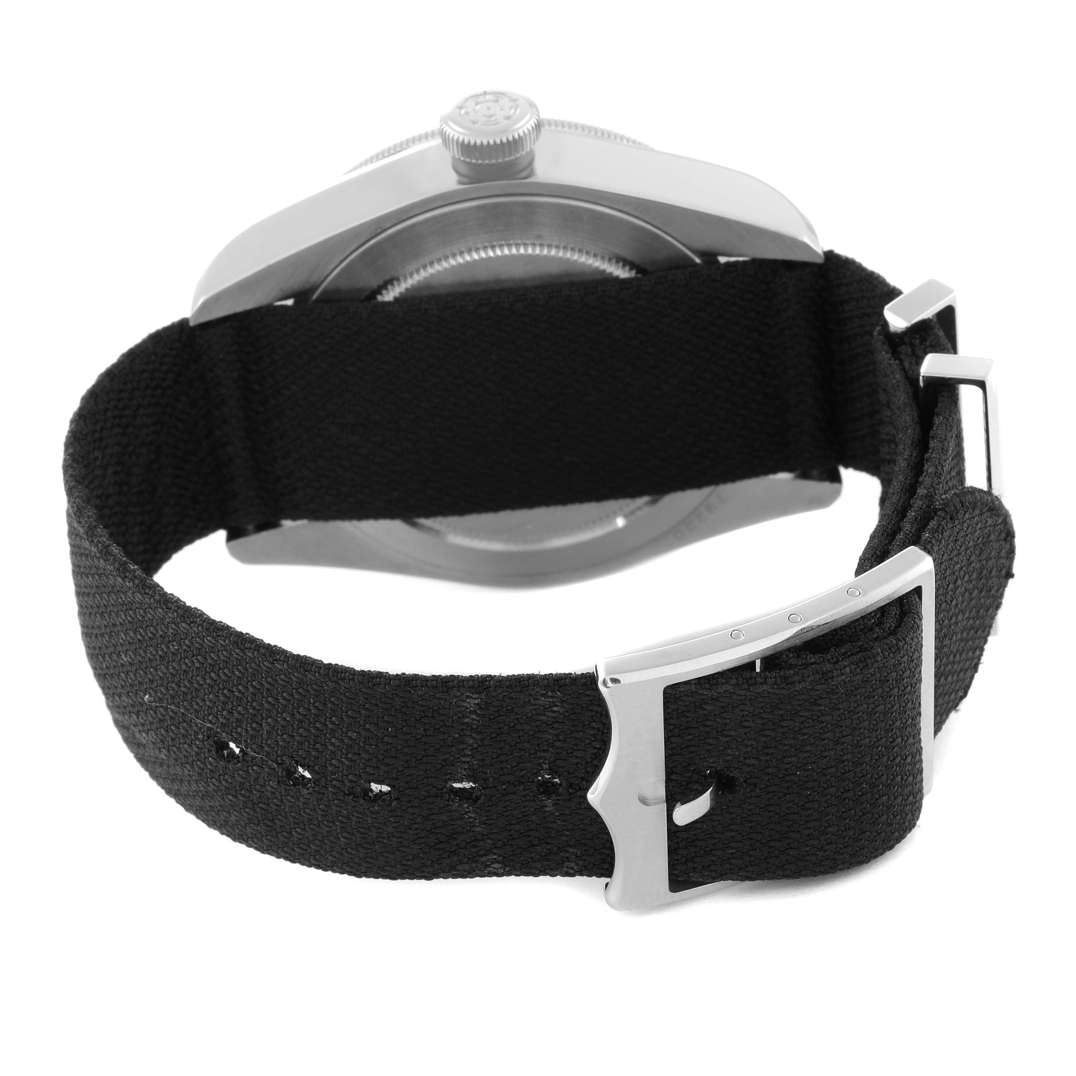 This image shows the back of the Tudor Heritage Black Bay 79220 Men
s Stainless Steel Black Dial 79220 Men
s Stainless Steel Black Dial watch, highlighting its case, crown, and black fabric strap with a buckle.