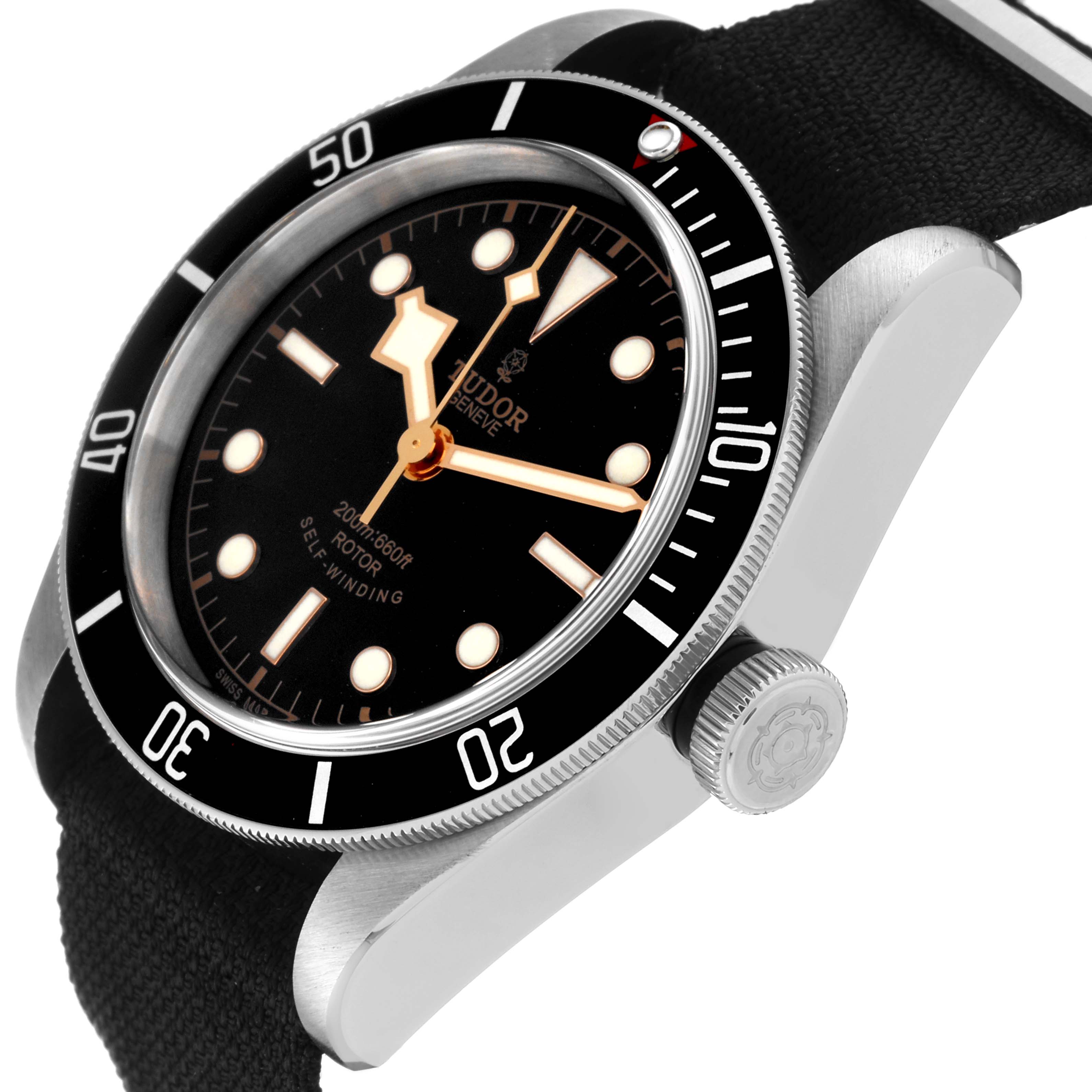 The Tudor Heritage Black Bay 79220 Men
s Stainless Steel Black Dial 79220 Men
s Stainless Steel Black Dial watch is shown at an oblique angle, showcasing its black dial, bezel, and crown.