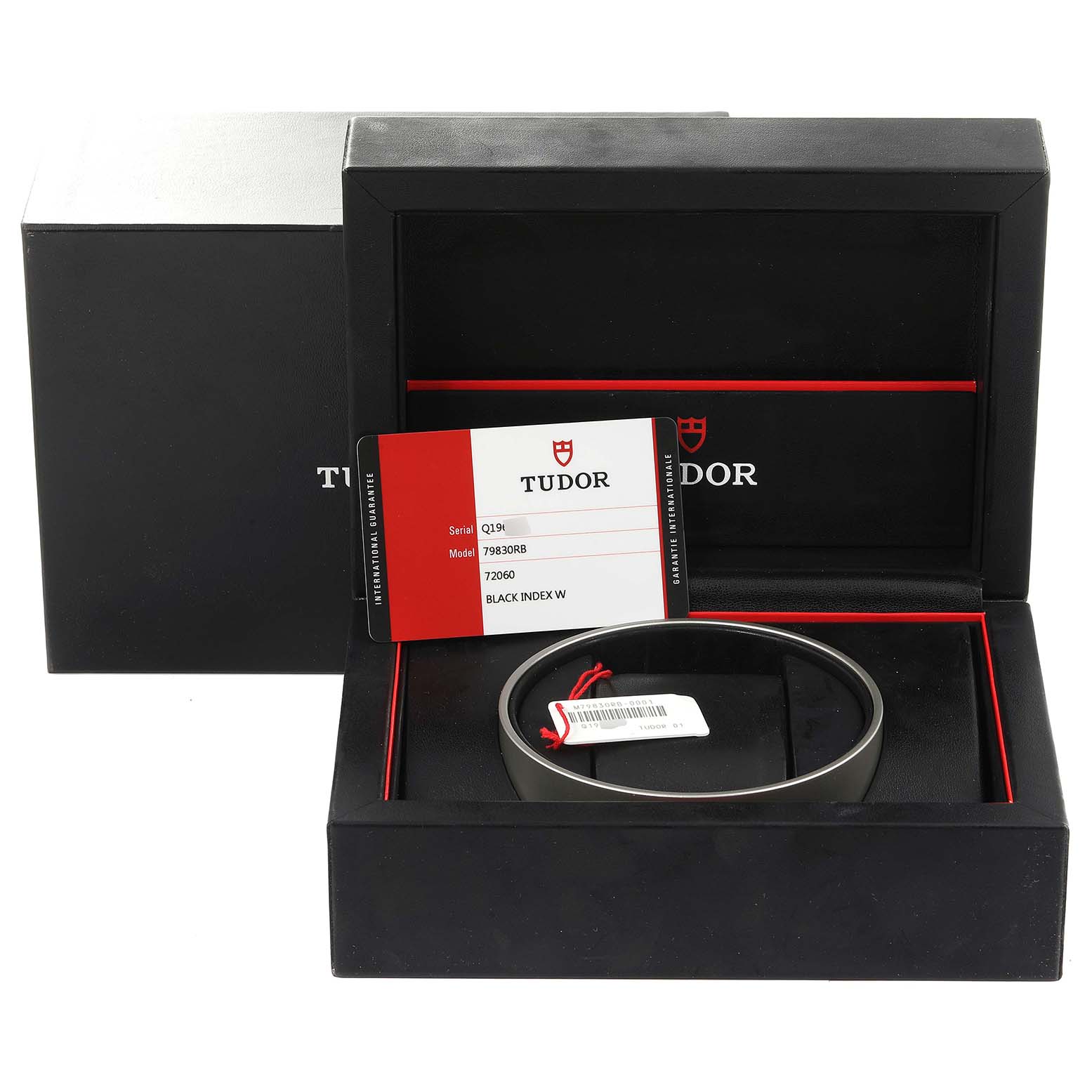 The image shows the packaging, warranty card, and bezel of the Tudor Heritage Black Bay 79830RB Men
s Stainless Steel Black Dial 79830RB Men
s Stainless Steel Black Dial watch.
