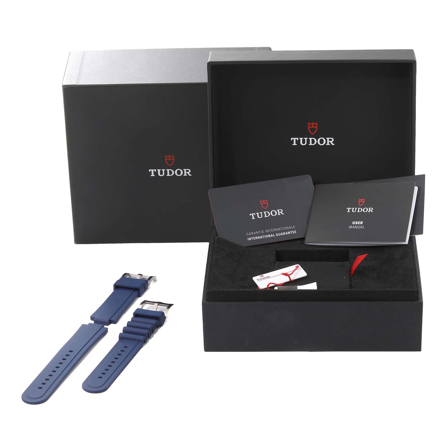 The image shows the packaging box, warranty card, user manual, and extra straps for the Tudor Pelagos 25600TB Men's Titanium Blue Dial 25600TB Men's Titanium Blue Dial watch.