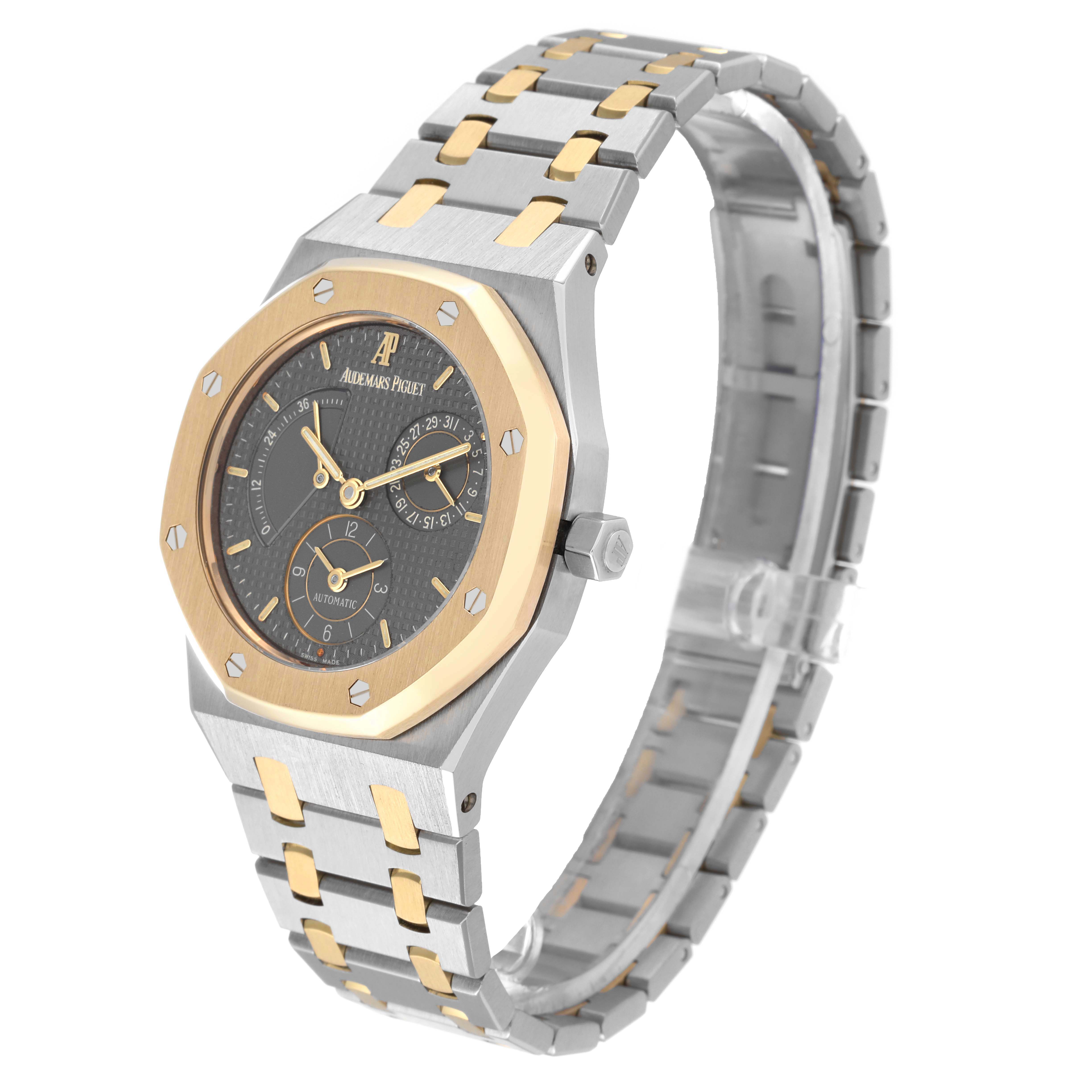 The Audemars Piguet Royal Oak 25730SA.01.078 Men's Steel and Gold (two tone) Grey Dial 25730SA.01.078 Men's Steel and Gold (two tone) Grey Dial watch is shown at a three-quarter angle, highlighting its two-tone bracelet, bezel, and detailed dial.