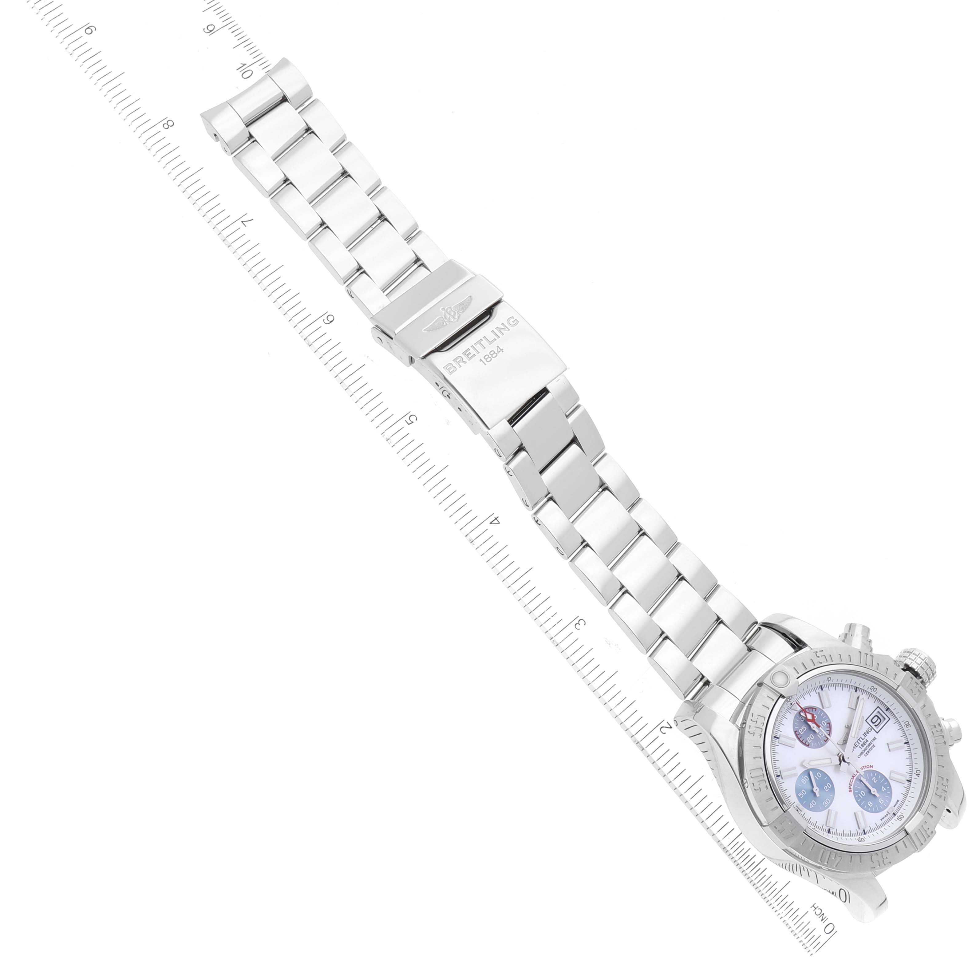 The image shows a Breitling Avenger A13381 Men's Stainless Steel Mother of Pearl Dial A13381 Men's Stainless Steel Mother of Pearl Dial watch lying flat on its back, displaying its face and metal bracelet with a clasp.