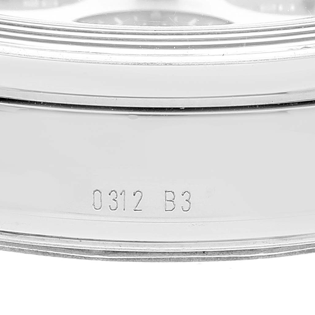 The image shows a close-up of the side casing of a Breitling Transocean AB015212/G724 Men's Stainless Steel Silver Dial AB015212/G724 Men's Stainless Steel Silver Dial watch, focusing on the engraved serial number.