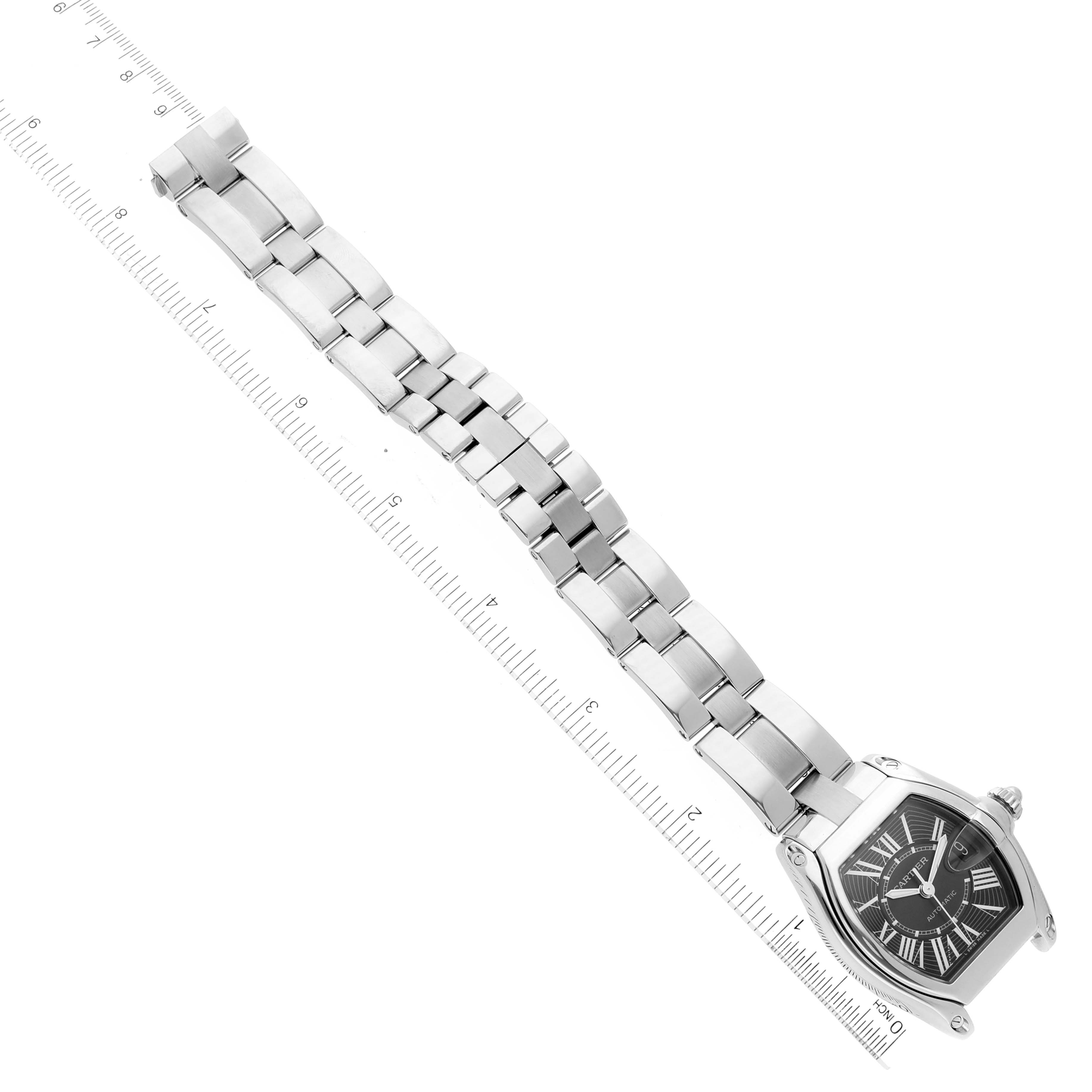 The Roadster model by Cartier is shown from a top-down angle, displaying the face and full metal bracelet with a ruler for scale.
