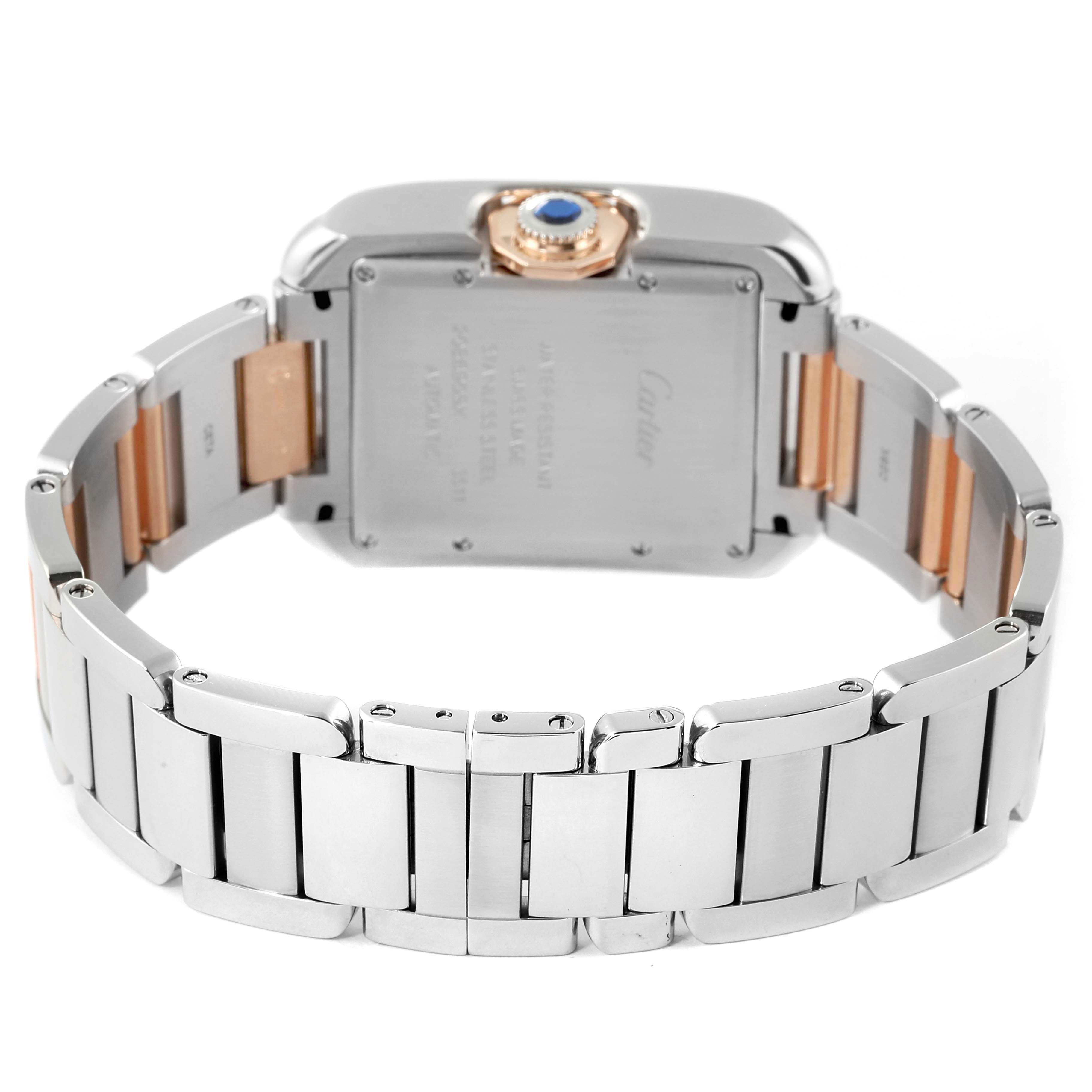 The image shows the back and bracelet of a Cartier Tank Anglaise WT100025 Women's Steel and Gold (two tone) Silver Dial WT100025 Women's Steel and Gold (two tone) Silver Dial watch, highlighting its metallic links and crown with a blue gemstone.