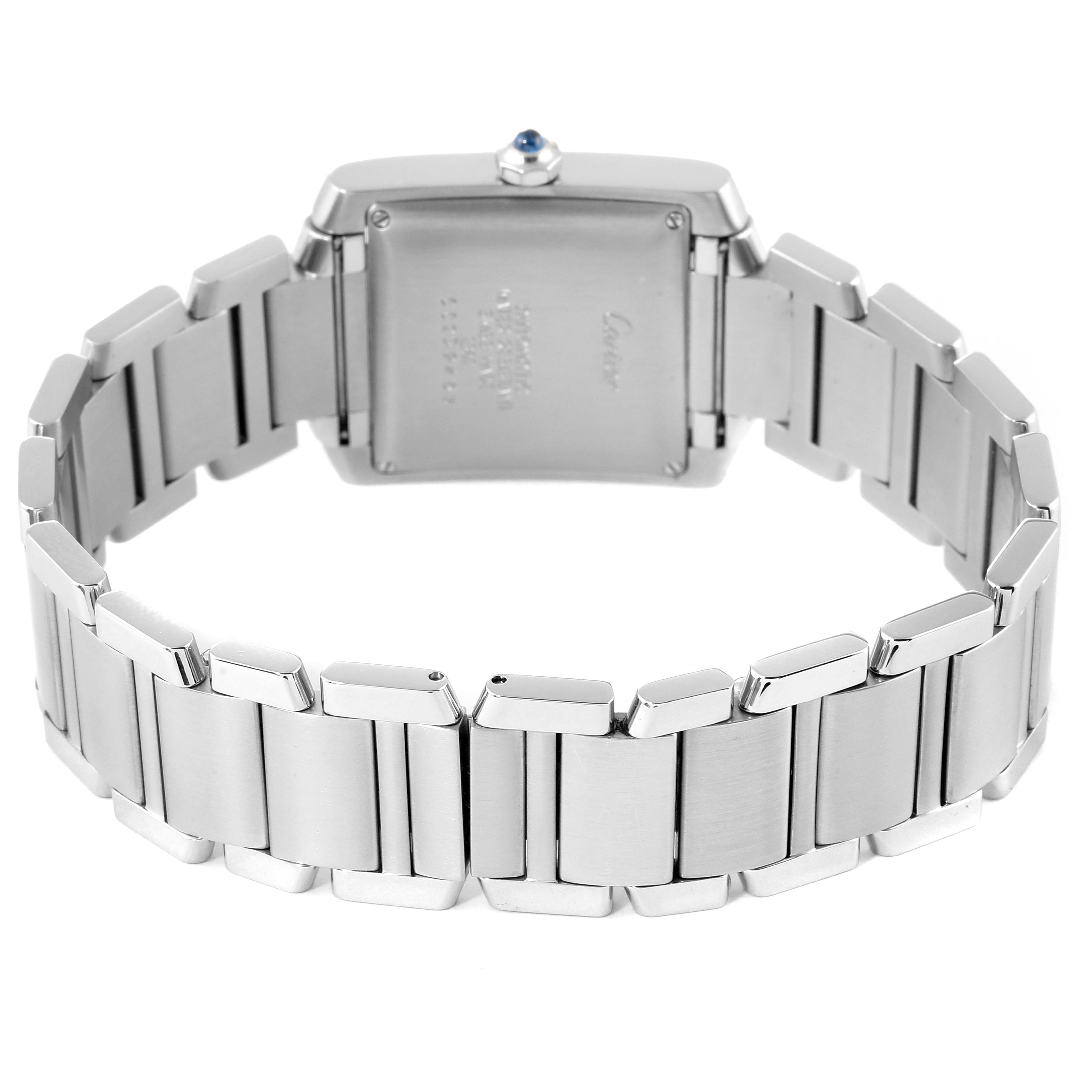 The image shows the back and bracelet of a Cartier Tank Française watch, highlighting its stainless steel links and case back.