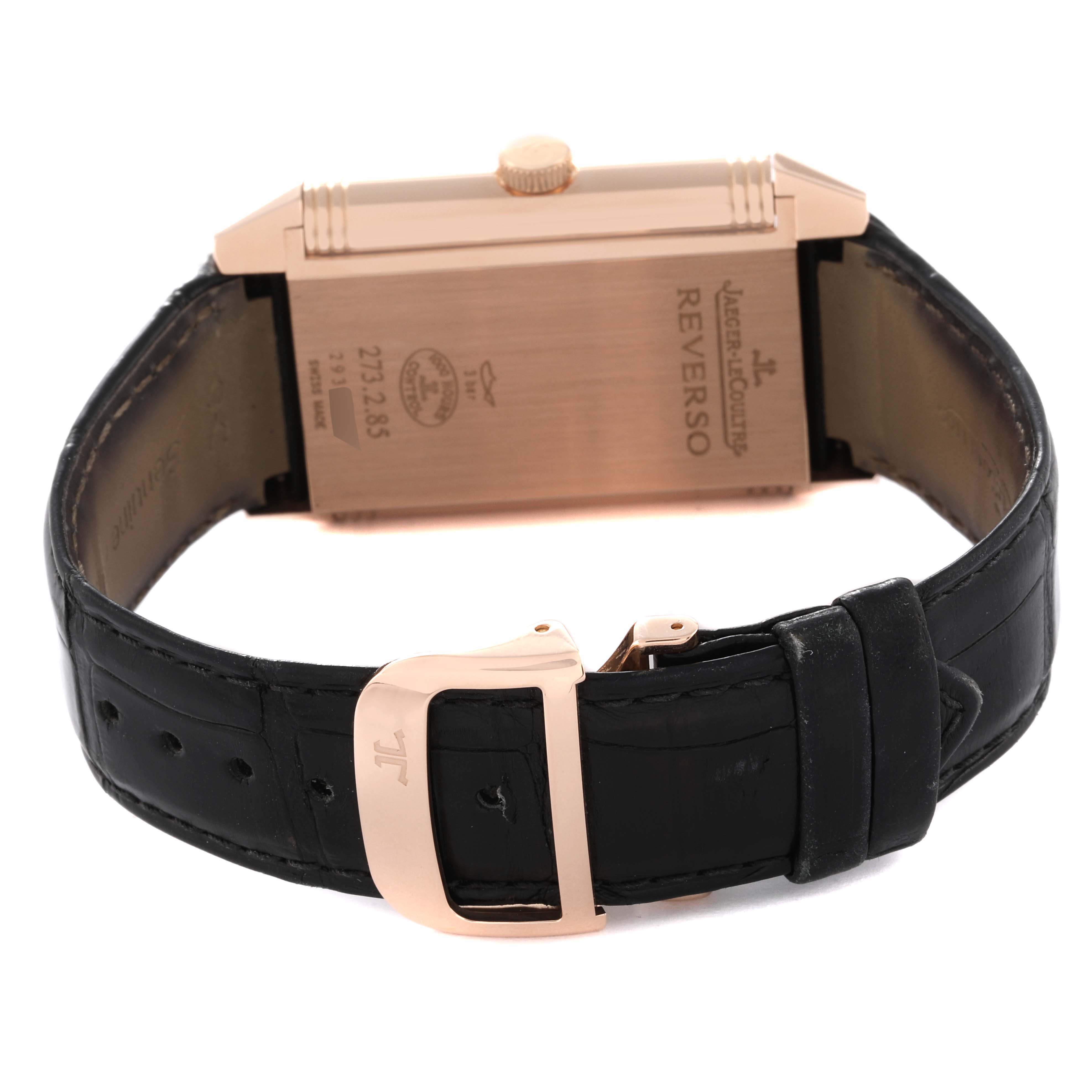 The image shows the back view of a Jaeger-LeCoultre Reverso watch, displaying its caseback and black leather strap with a buckle.