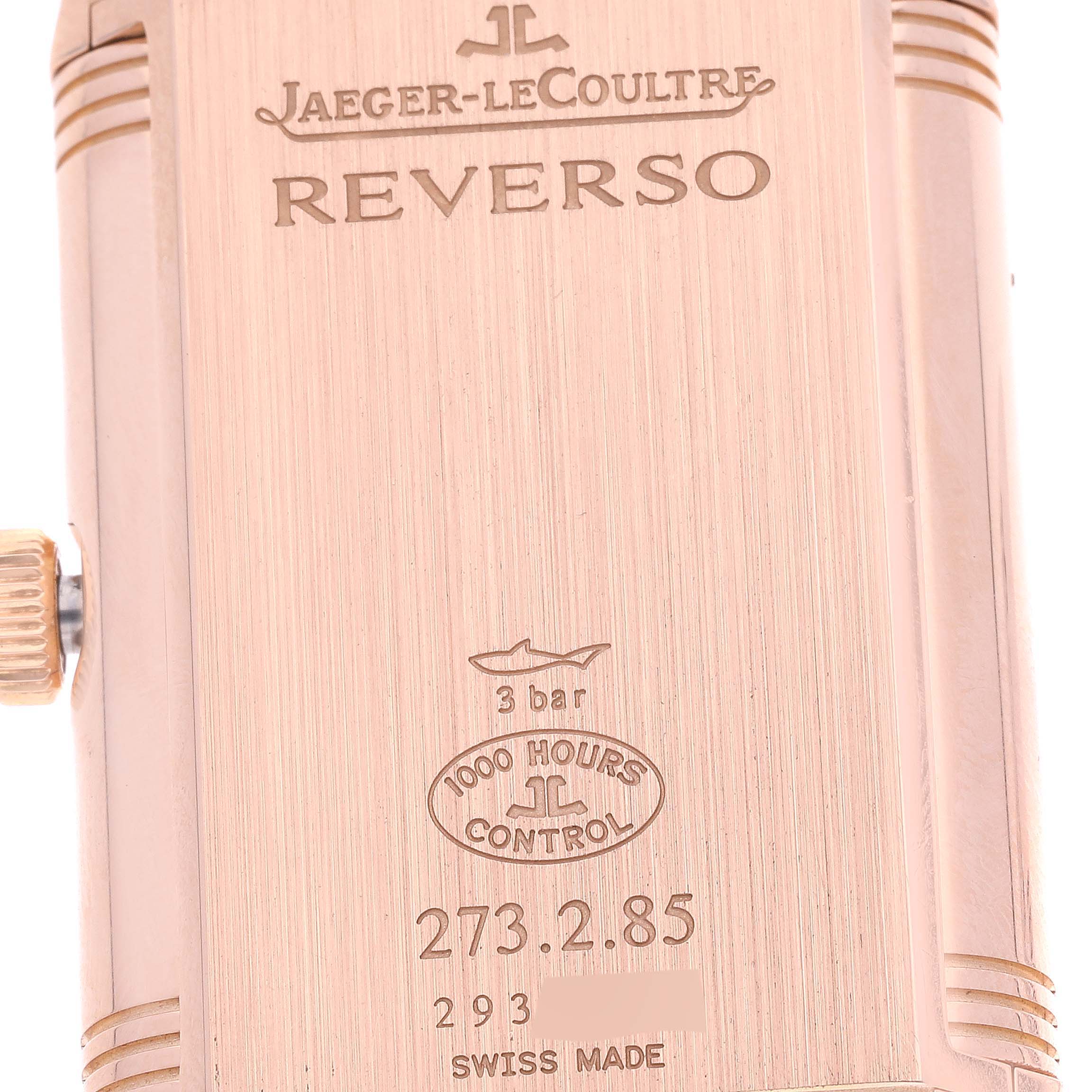 The image shows the case back of a Jaeger-LeCoultre Reverso watch, displaying the brand, model name, water resistance, and serial number.
