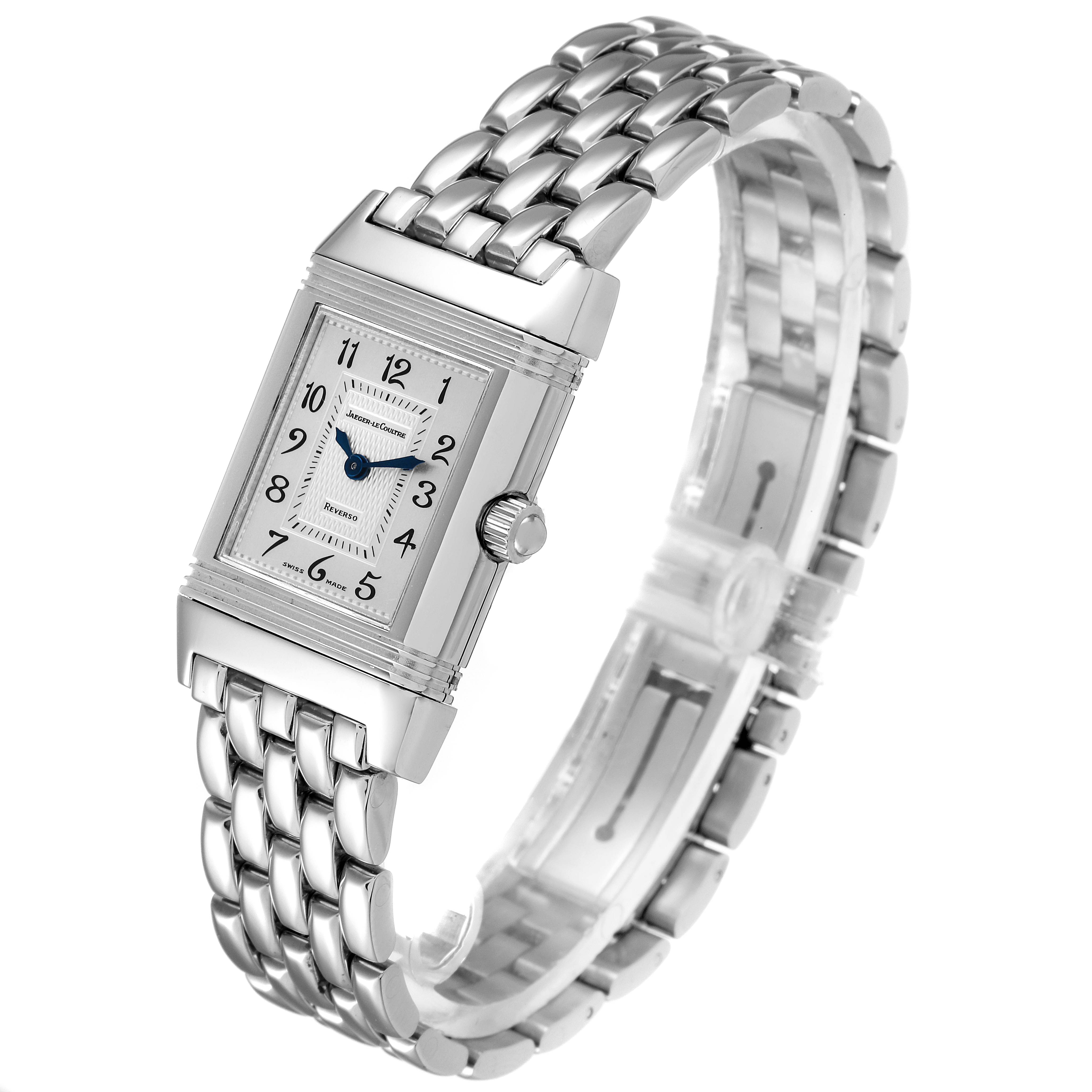 The image shows a Jaeger-LeCoultre Reverso watch, featuring its rectangular case, dial, and metal bracelet from a slightly tilted angle.