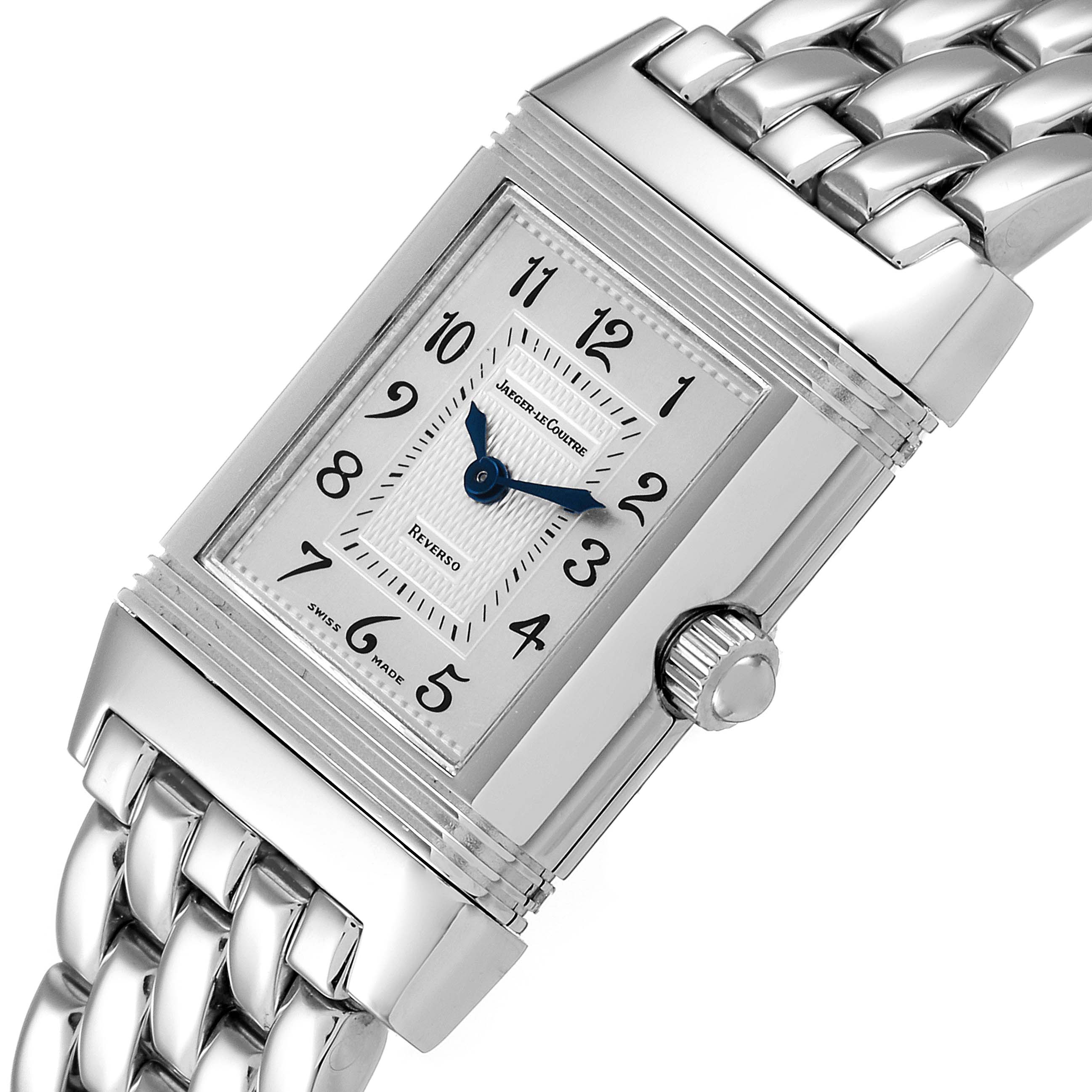 The image shows a close-up of the Jaeger-LeCoultre Reverso watch's dial, crown, and metal bracelet from an angled perspective.
