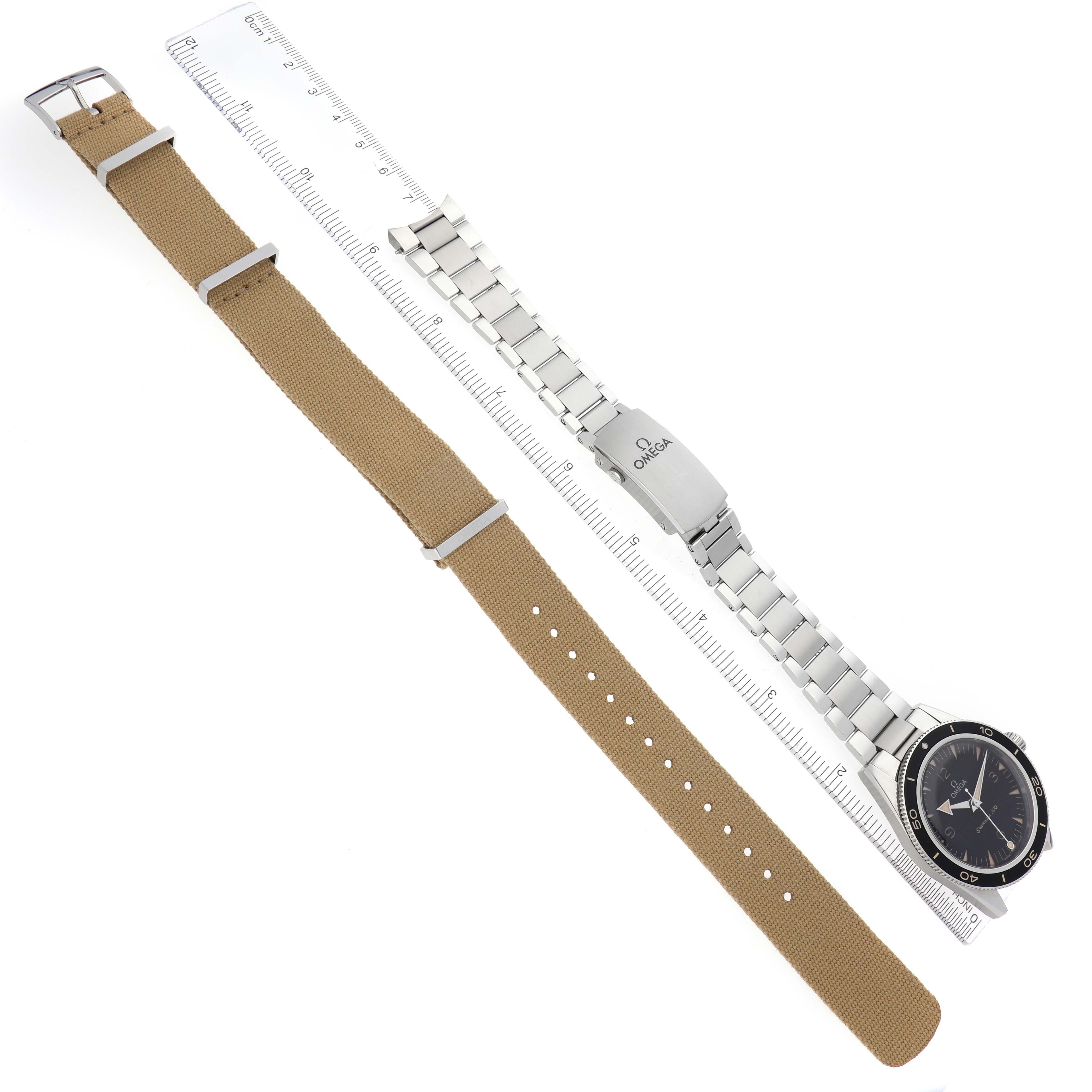 The image shows an Omega Seamaster model 234.30.41.21.01.001 watch with a stainless steel bracelet, a black bezel, and an additional tan textile strap, viewed from above.