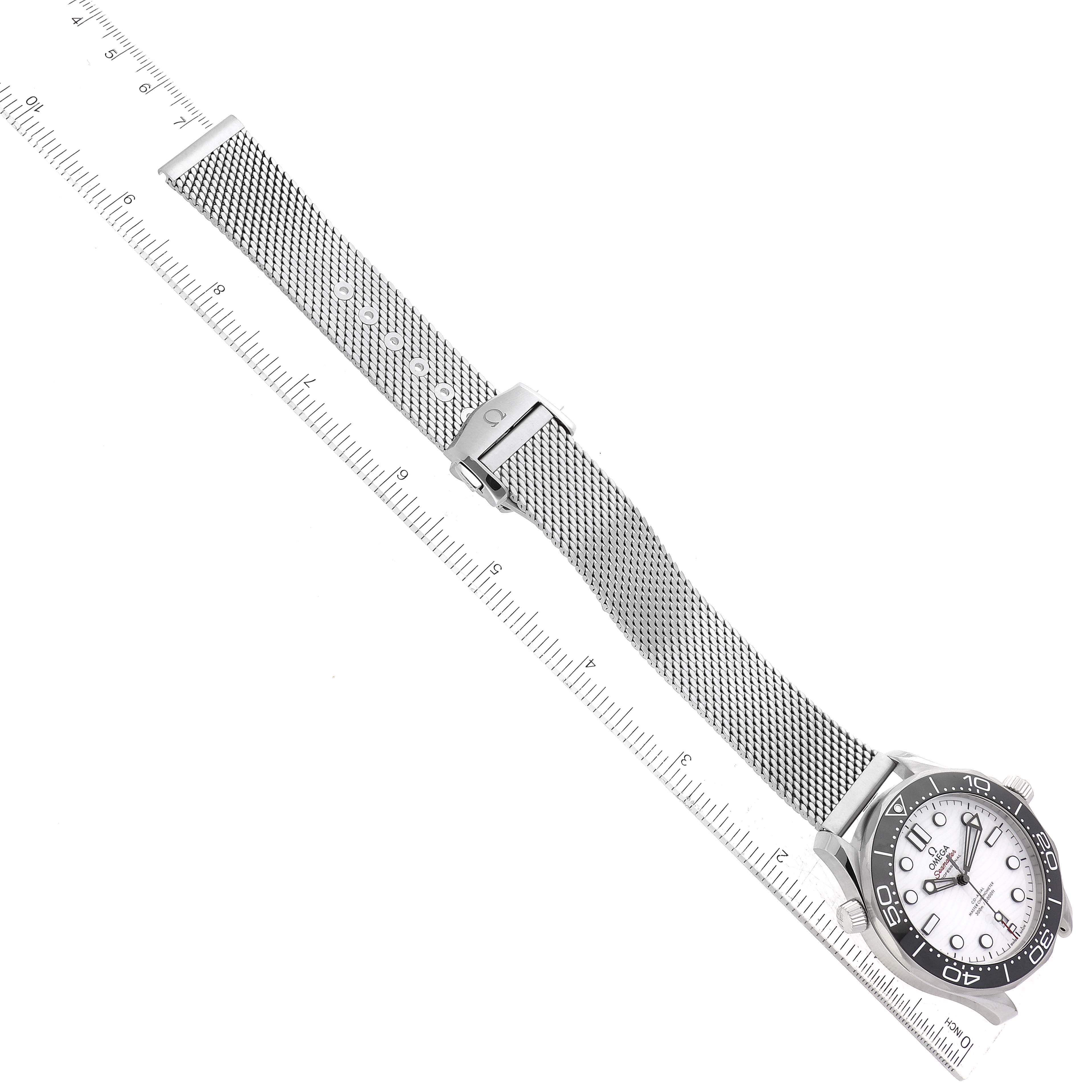 The image shows an Omega Seamaster 210.32.42.20.04.001 Men
s Stainless Steel White Dial 210.32.42.20.04.001 Men
s Stainless Steel White Dial watch laid flat with a mesh strap and placed next to a ruler for measurement.
