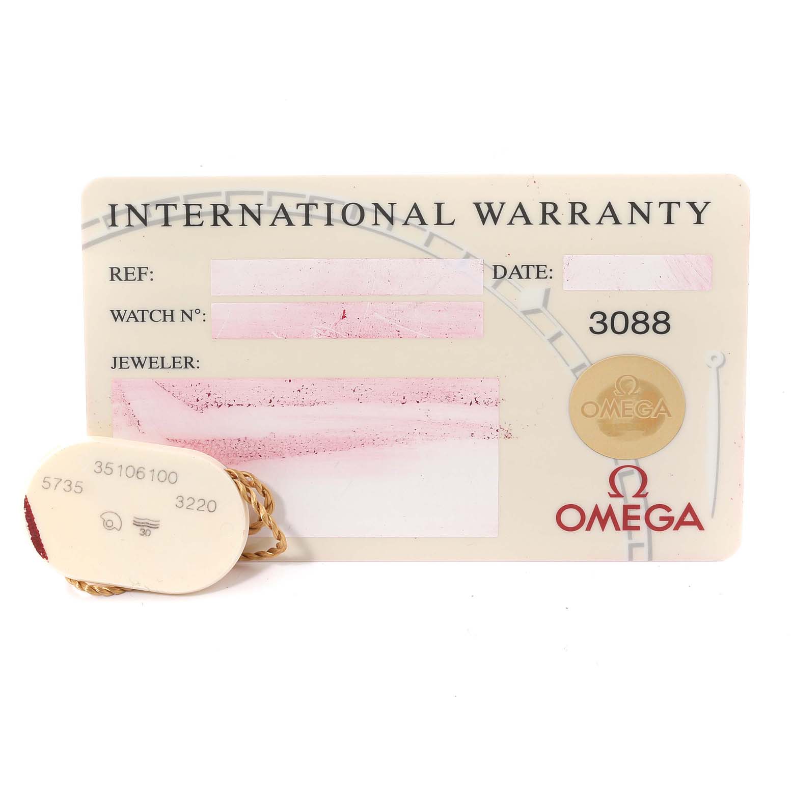 The image shows an Omega Speedmaster 3510.61.00 Men's Stainless Steel Red Dial 3510.61.00 Men's Stainless Steel Red Dial's International Warranty card and a tag with reference numbers.