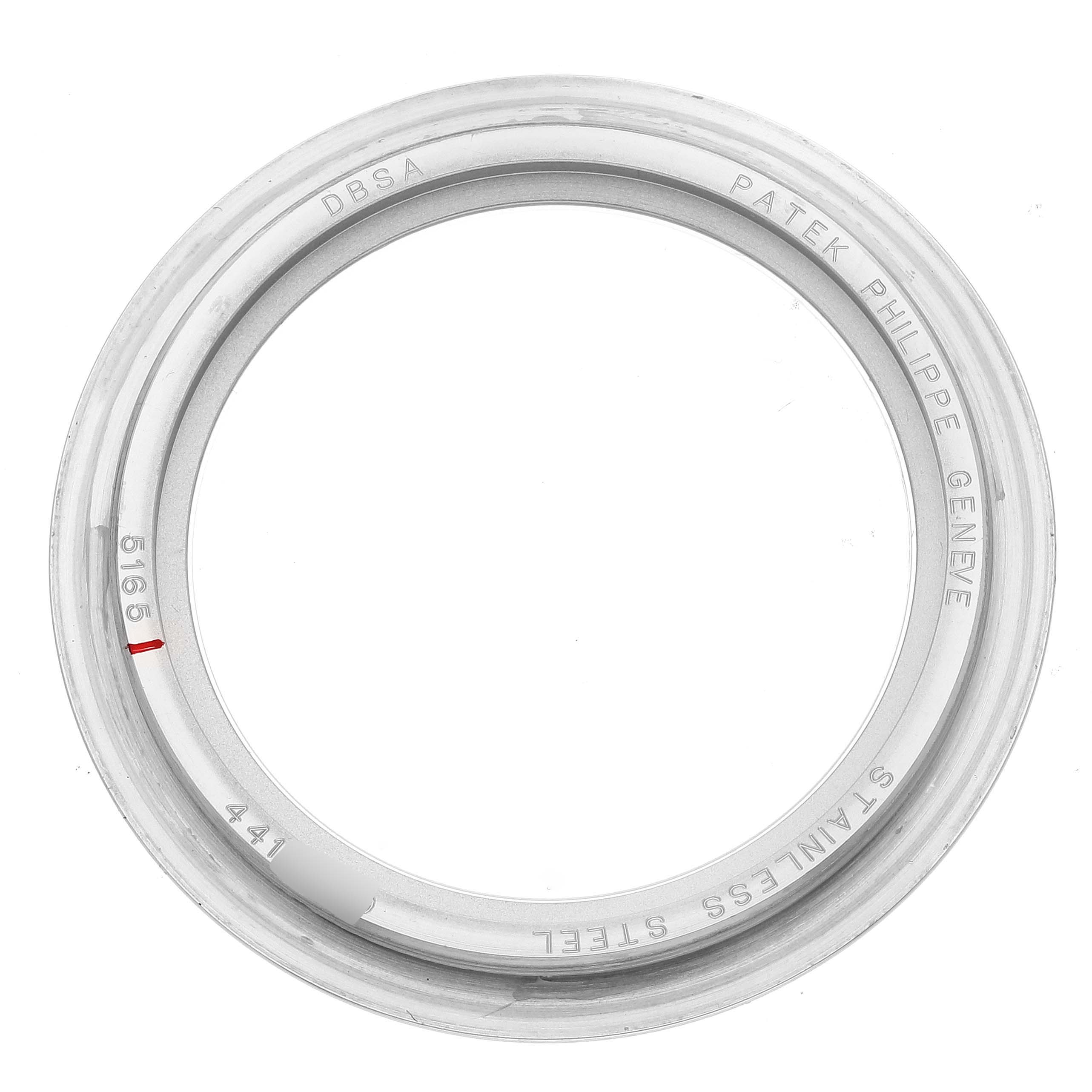 This is a top-down view of a stainless steel bezel for a Patek Philippe Aquanaut 5165A-001 Men's Stainless Steel Black Dial 5165A-001 Men's Stainless Steel Black Dial watch, displaying the brand and model engravings.