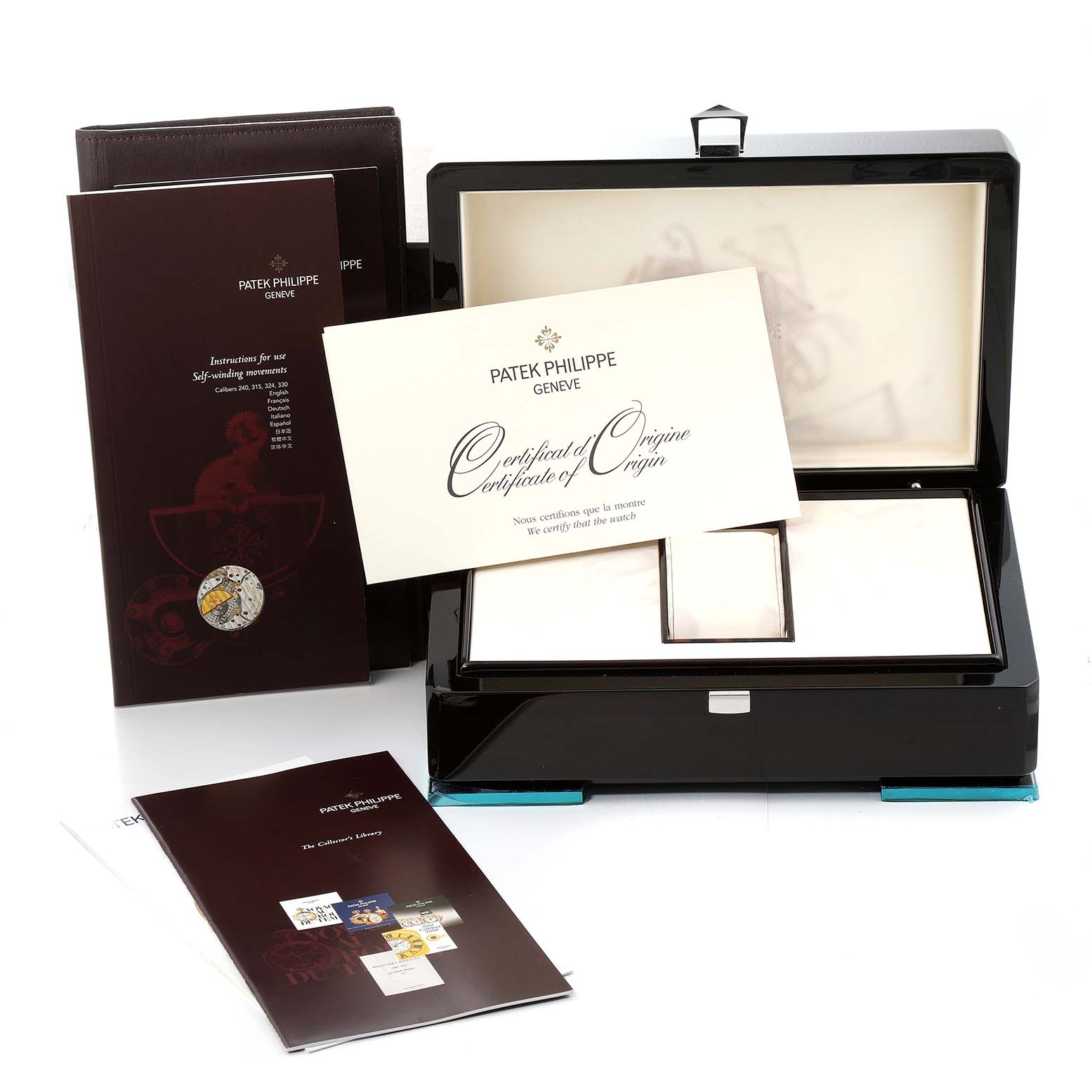 The image shows the packaging, instruction manuals, and certificate of origin for a Patek Philippe Aquanaut 5165A-001 Men's Stainless Steel Black Dial 5165A-001 Men's Stainless Steel Black Dial watch.