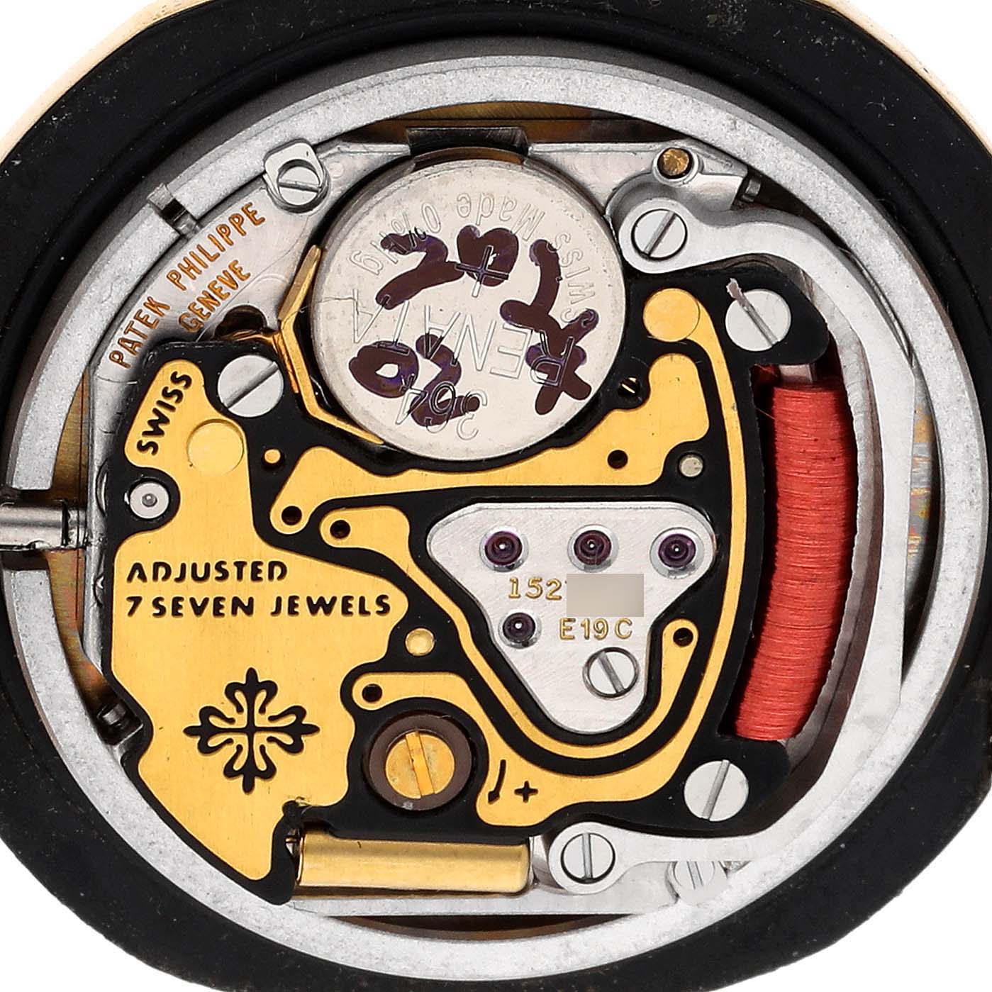 This image shows the inner mechanical movement of a Patek Philippe Nautilus 4700 Women's Yellow Gold Black Dial 4700 Women's Yellow Gold Black Dial watch, including the battery, jewels, and intricate components.