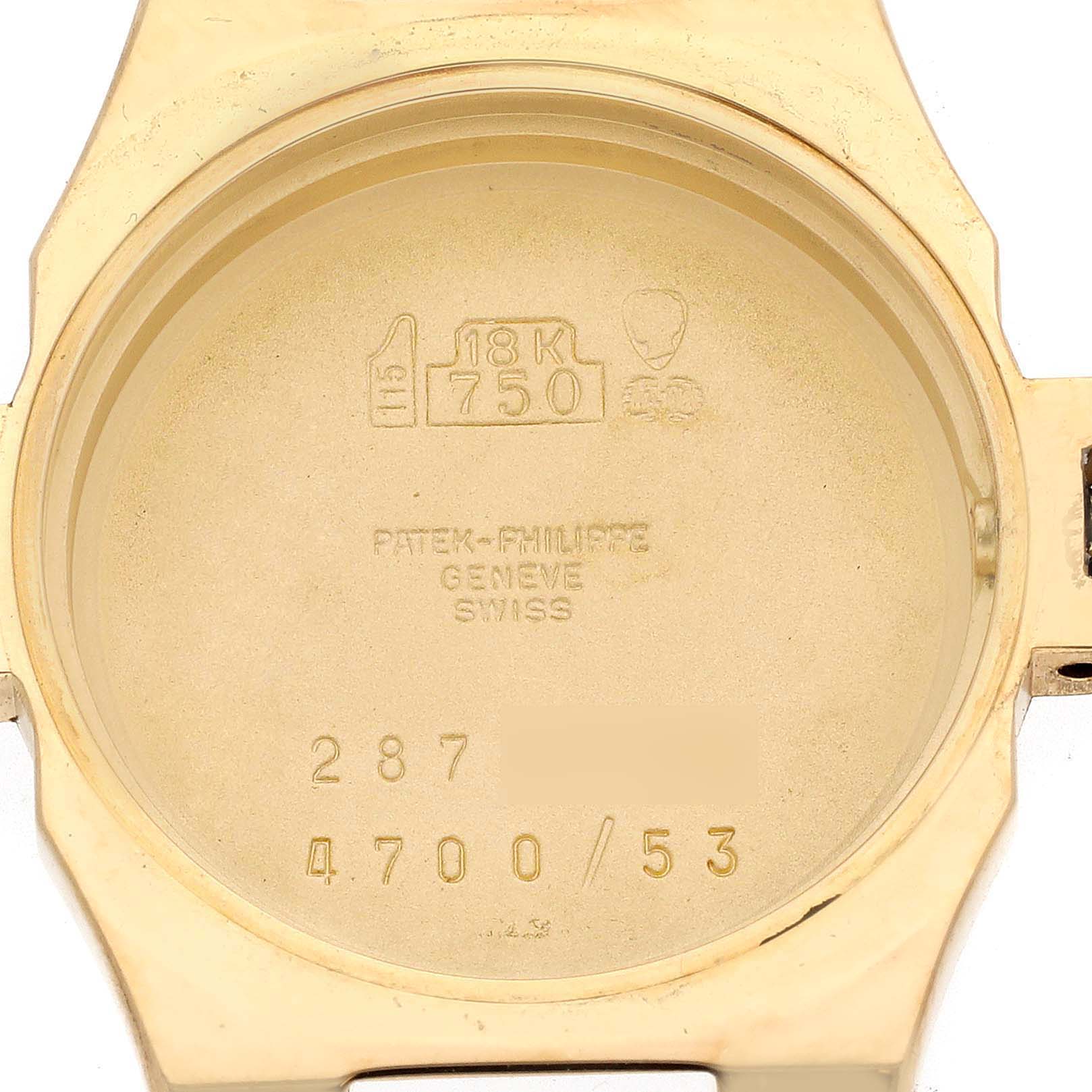 This image shows the inner case back of a Patek Philippe Nautilus 4700 Women's Yellow Gold Black Dial 4700 Women's Yellow Gold Black Dial watch, displaying hallmarks and inscriptions.