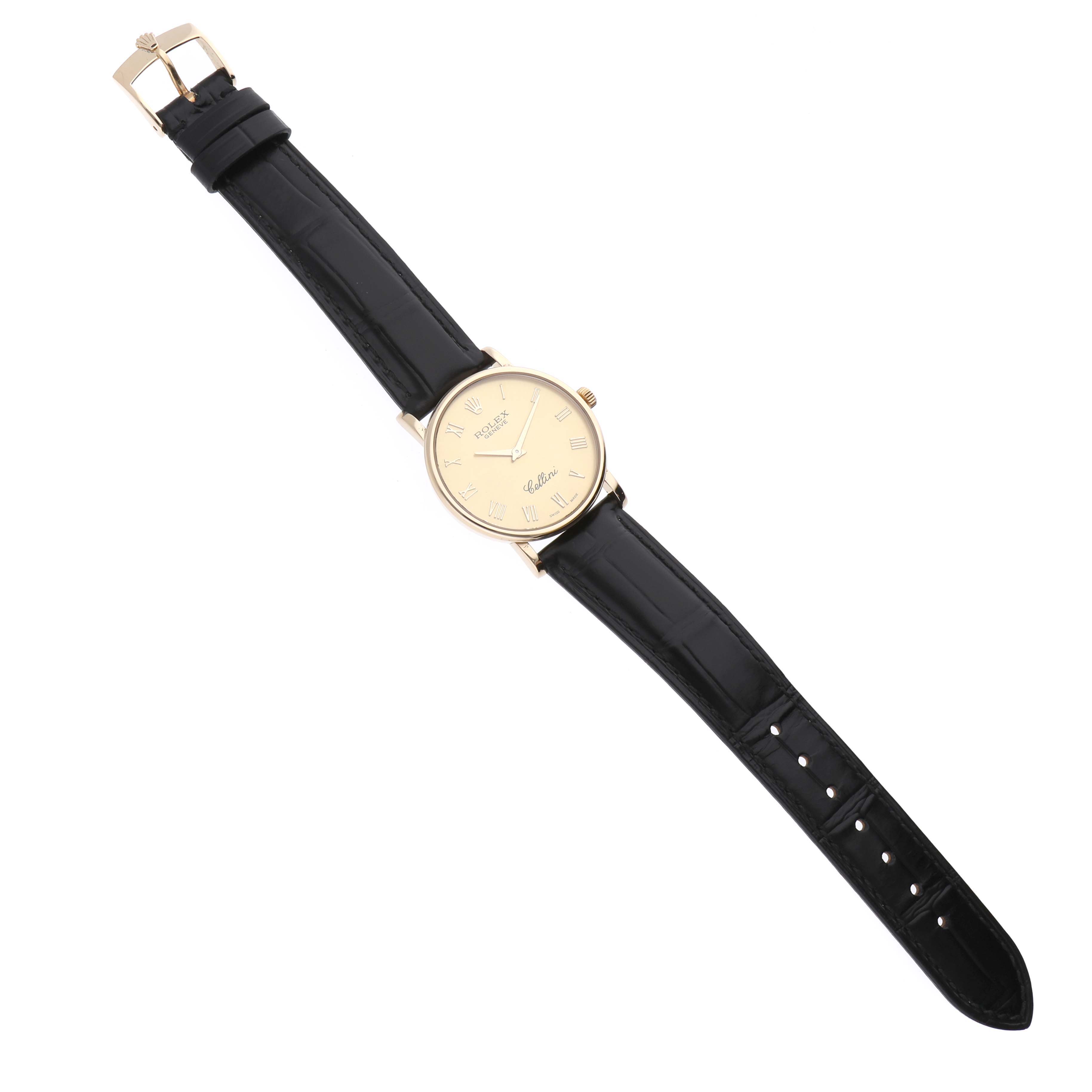 The Rolex Cellini 5115 Men's Yellow Gold Champagne Dial 5115 Men's Yellow Gold Champagne Dial watch is shown in its entirety from a top-down angle, displaying its face and black leather strap.