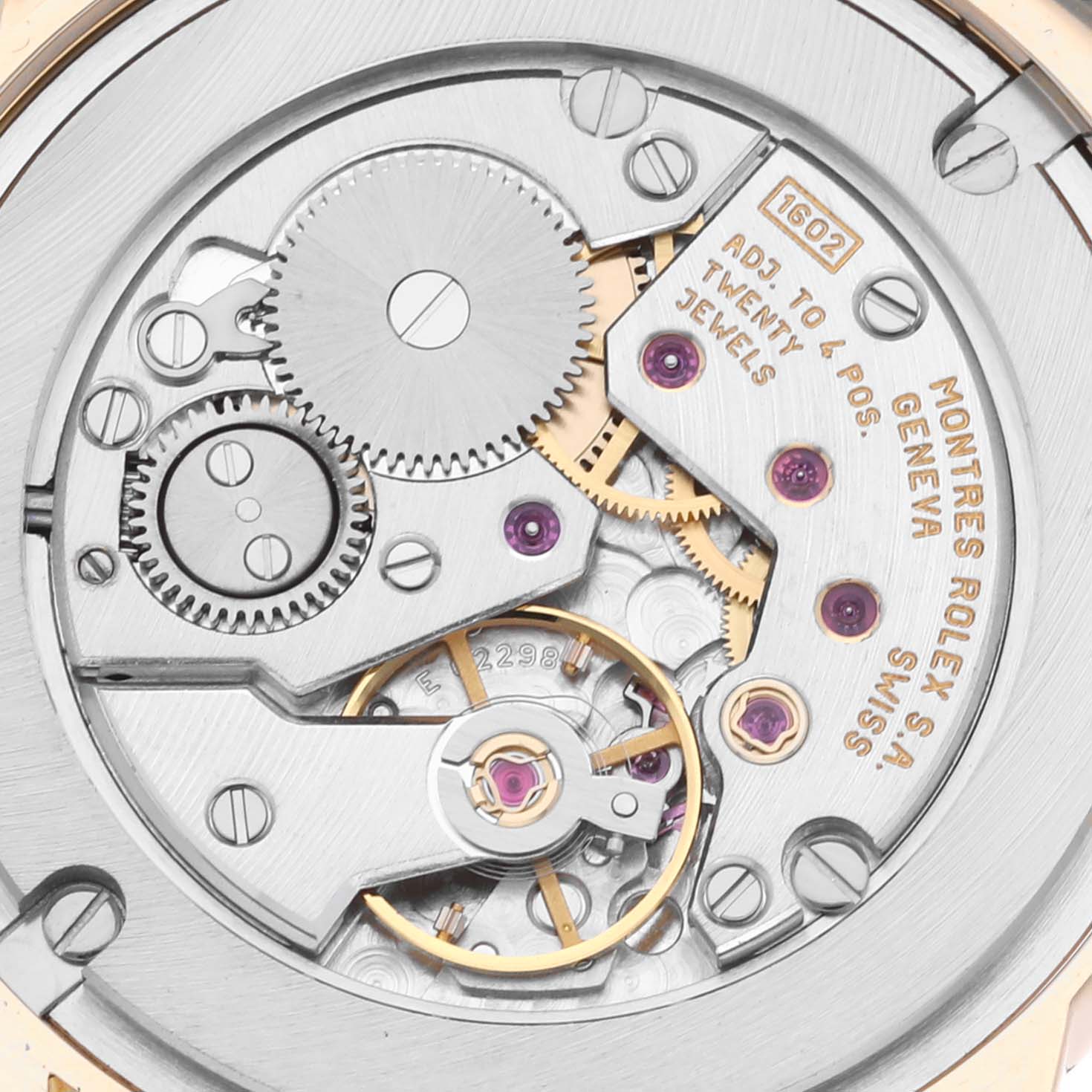 This image shows a close-up of the internal mechanism of a Rolex Cellini 5116/8 Men's Yellow Gold White Dial 5116/8 Men's Yellow Gold White Dial watch, highlighting the gears, jewels, and inscriptions.