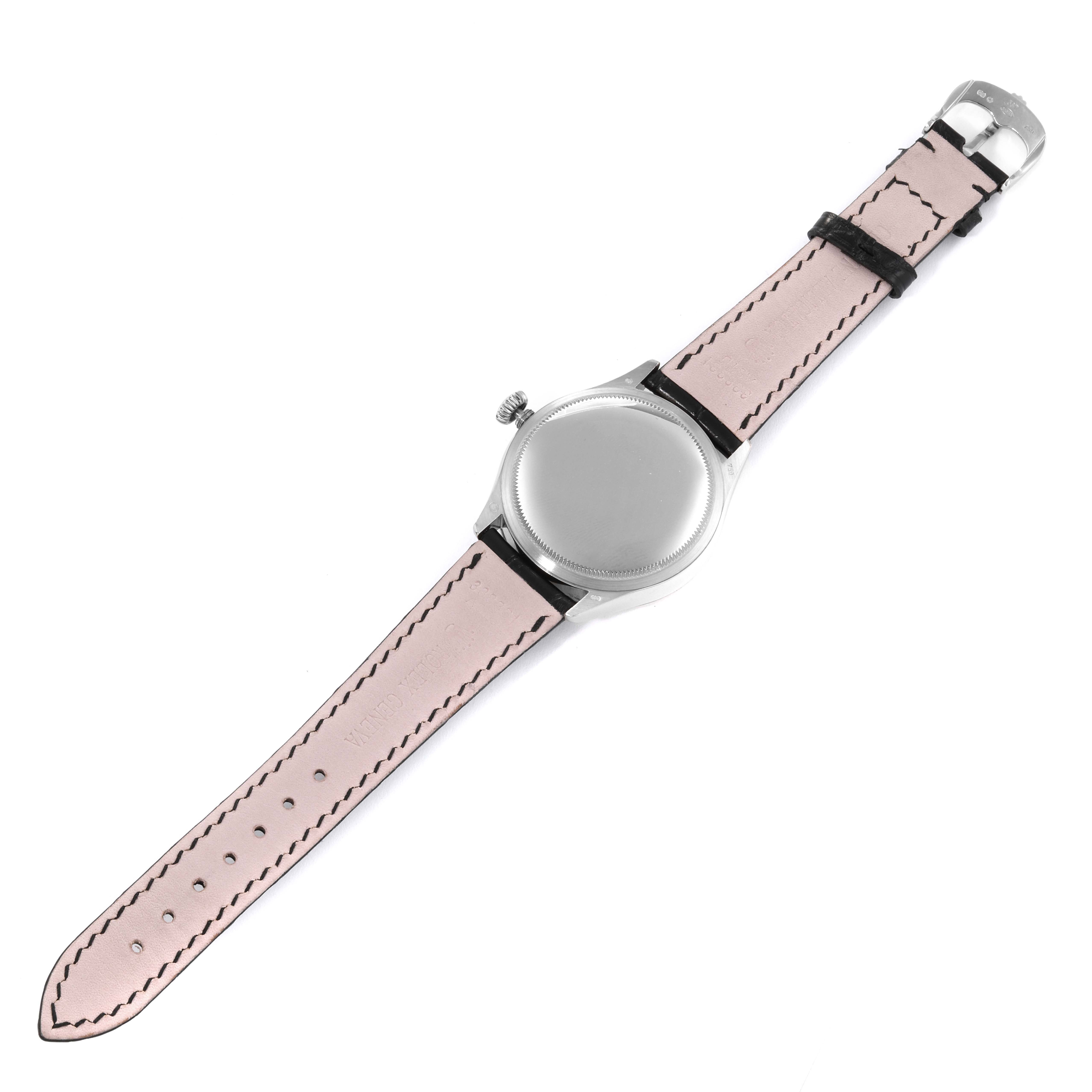 The Rolex Cellini 50519 Men's White Gold Blue Dial 50519 Men's White Gold Blue Dial watch is shown from the back, highlighting its case back, crown, and leather strap.