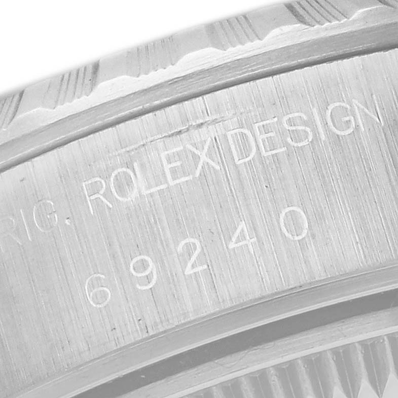 The image shows a close-up view of the engravings on the case back of the Rolex Date 69240 Women
s Stainless Steel Blue Dial 69240 Women
s Stainless Steel Blue Dial model watch.