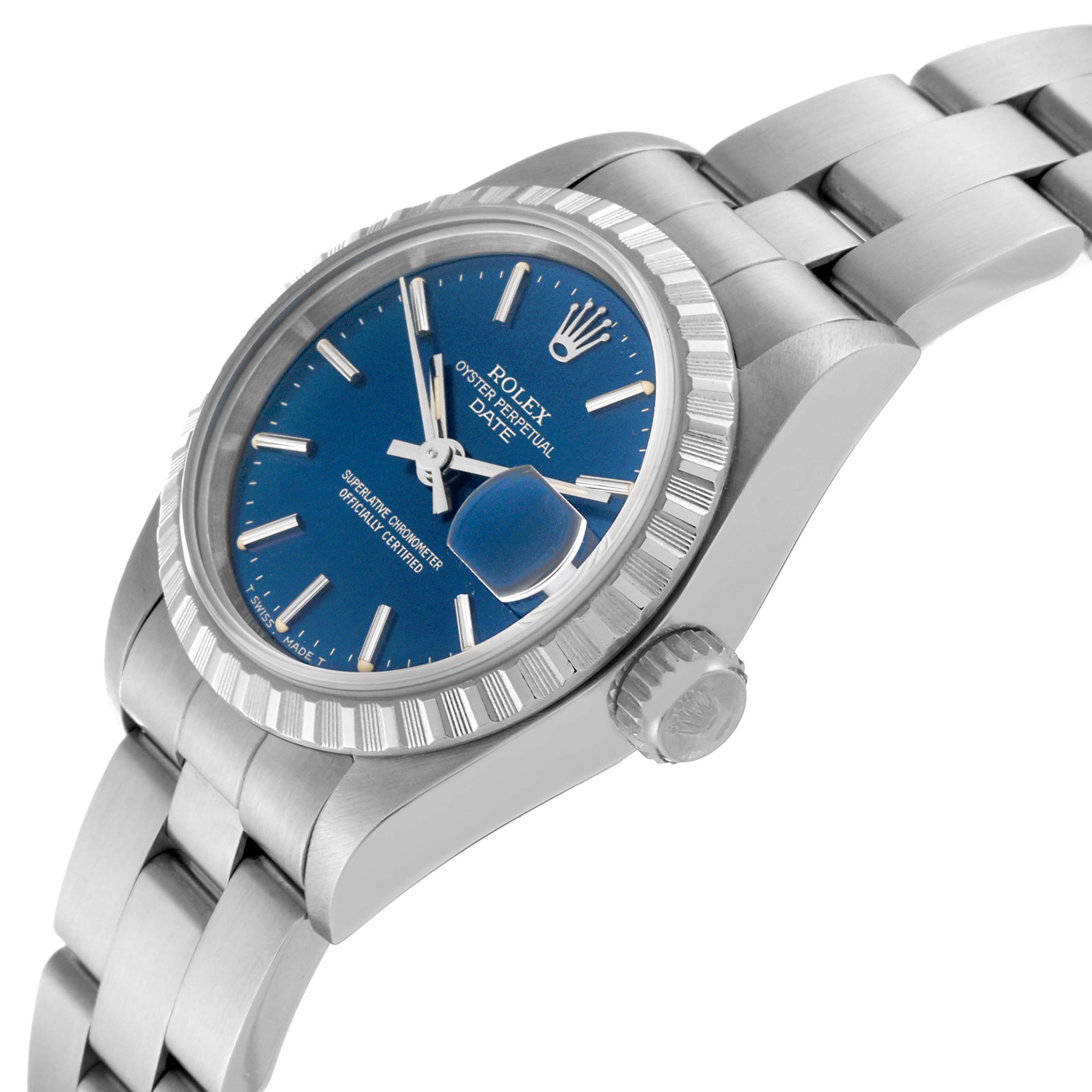 The image shows a side view of the Rolex Date 69240 Women
s Stainless Steel Blue Dial 69240 Women
s Stainless Steel Blue Dial model, highlighting the blue dial, fluted bezel, crown, and part of the bracelet.