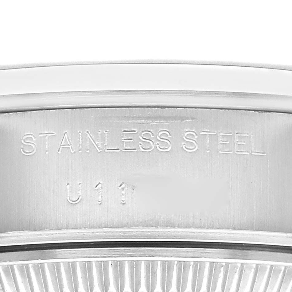This close-up image shows the stainless steel engraving on the case of a Rolex Date 69160 Women's Stainless Steel Blue Dial 69160 Women's Stainless Steel Blue Dial watch.