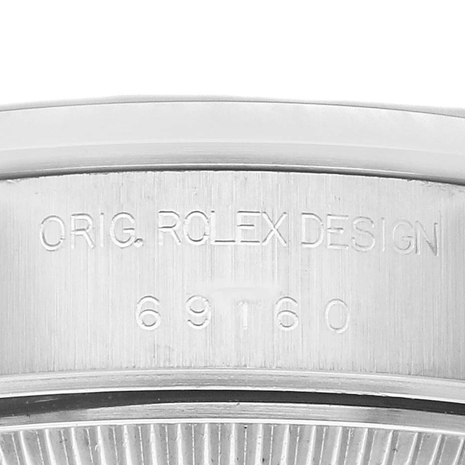 The image shows a close-up of the case detailing on a Rolex Date 69160 Women's Stainless Steel Blue Dial 69160 Women's Stainless Steel Blue Dial model, highlighting the engraved serial number.