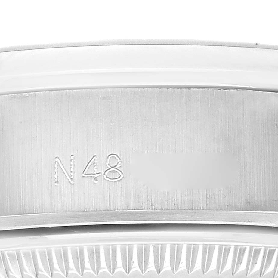 The image shows a close-up angle of the engraved bezel and part of the case for a Rolex Date 69160 Women
s Stainless Steel Grey Dial 69160 Women
s Stainless Steel Grey Dial model watch.