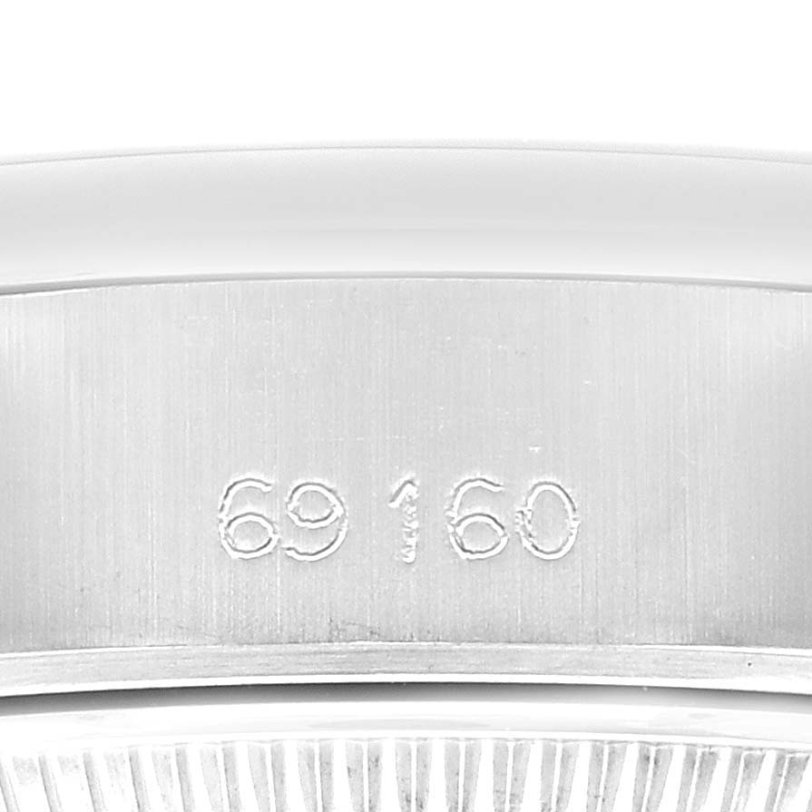 The image shows a close-up view of the Rolex Date 69160 Women
s Stainless Steel Grey Dial 69160 Women
s Stainless Steel Grey Dial model, focusing on its serial number engraving on the inner watch case.