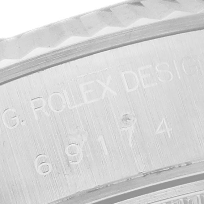 This close-up image shows the engraved text on the inner bezel of a Rolex Datejust 69174 Women's Stainless Steel Black Dial 69174 Women's Stainless Steel Black Dial watch.