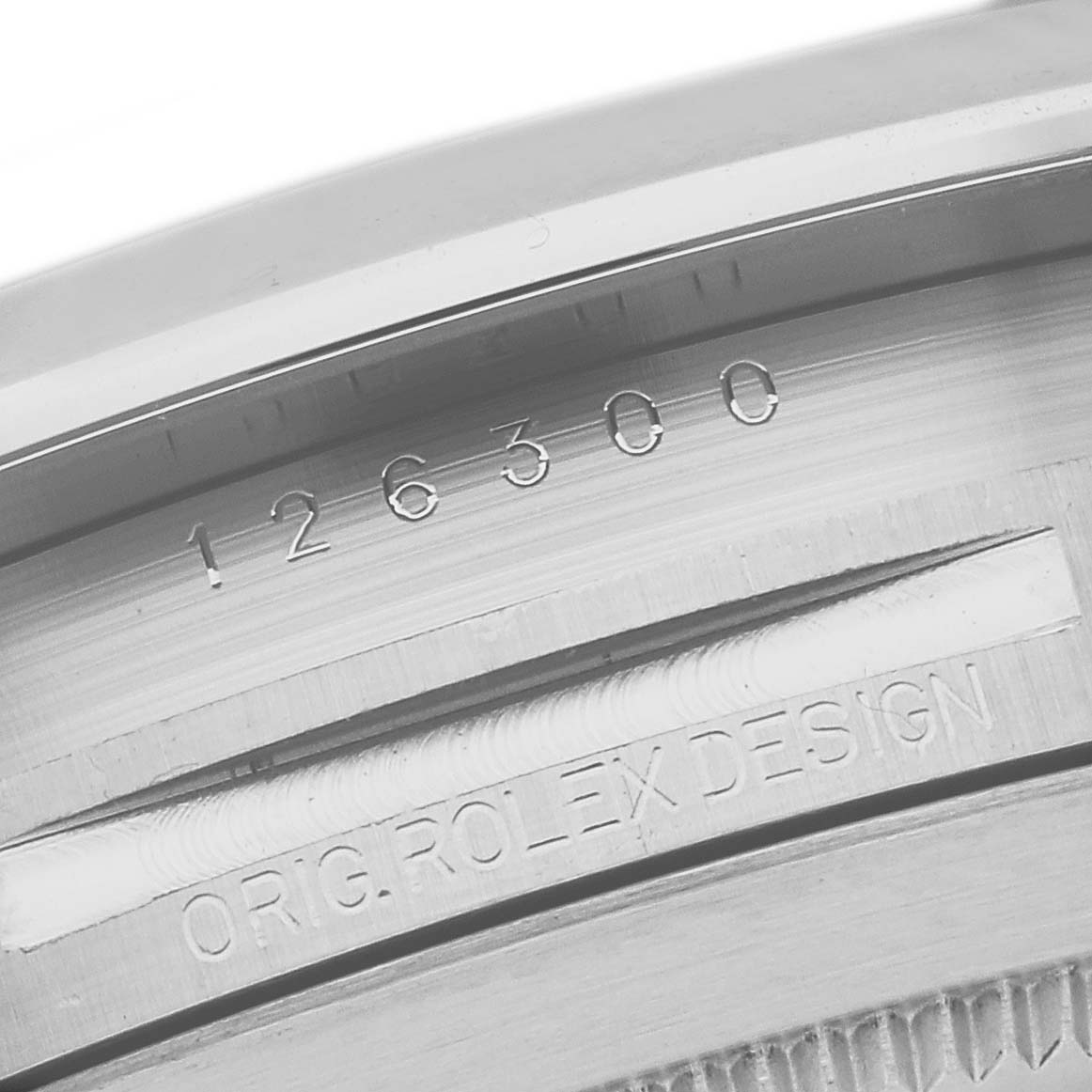 This image shows a close-up of the serial number and "ORIG ROLEX DESIGN" engraving on the side of a Rolex Datejust 41 126300 Men
s Stainless Steel Grey Dial 126300 Men
s Stainless Steel Grey Dial watch case.
