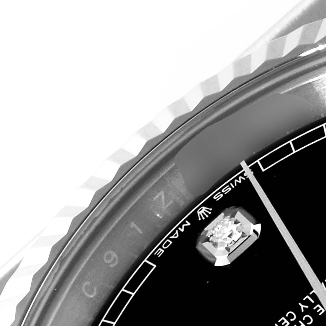 The image shows a close-up of the bezel and part of the dial of a Rolex Datejust 41 126334 Men's Stainless Steel Black Dial 126334 Men's Stainless Steel Black Dial watch, featuring a fluted bezel and a diamond hour marker.