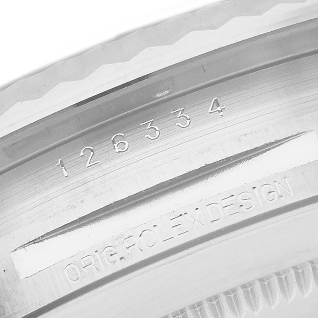 This image shows a close-up of the serial number and "ORIG. ROLEX DESIGN" engraving on the casing of the Rolex Datejust 41 126334 Men's Stainless Steel Black Dial 126334 Men's Stainless Steel Black Dial watch.