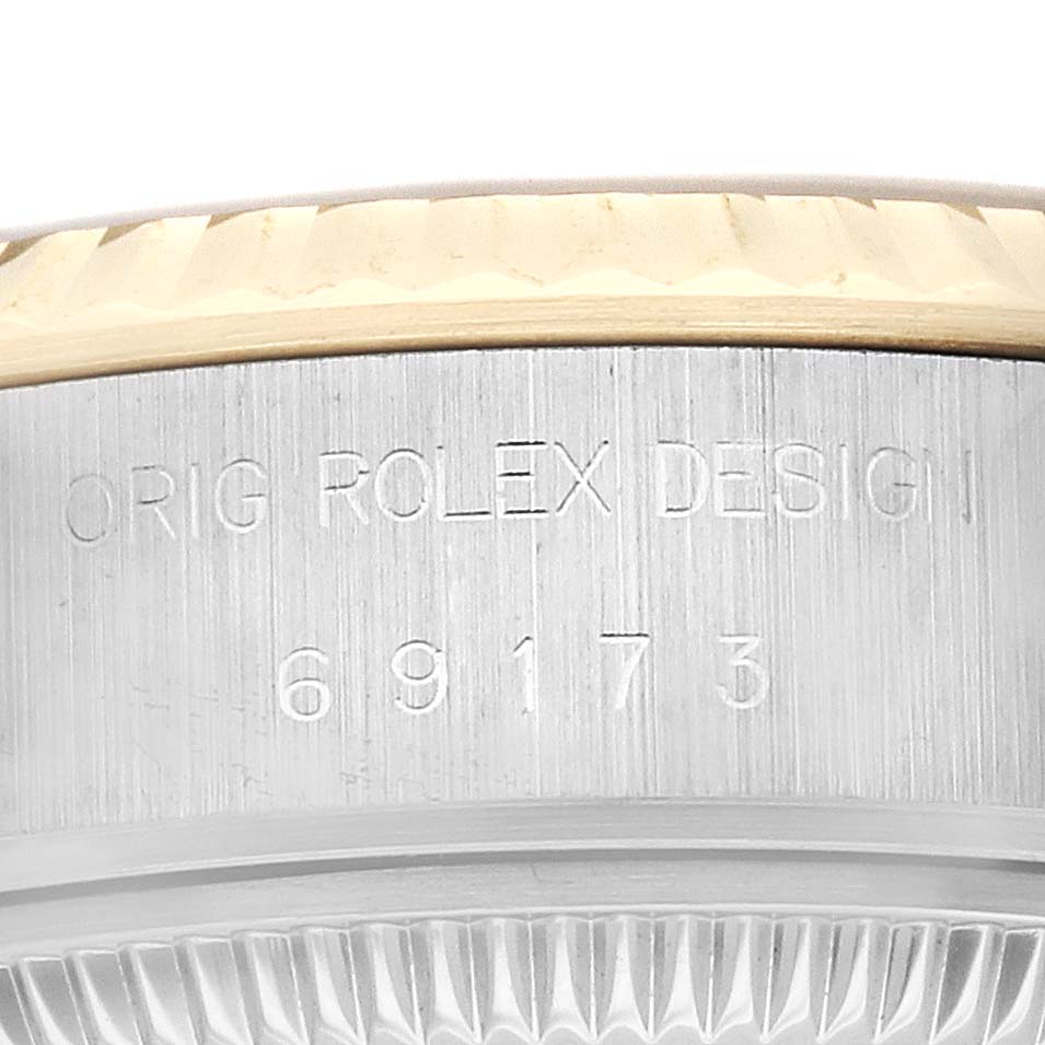 This close-up image shows the engraved side of the case on a Rolex Datejust 69173 Women's Steel and Gold (two tone) Champagne Dial 69173 Women's Steel and Gold (two tone) Champagne Dial watch.