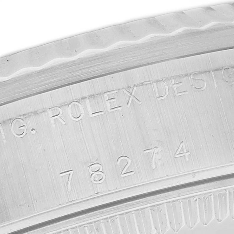 This close-up image shows the engraving on the side of the bezel of a Rolex Mid-Size 78274 Women's Stainless Steel Silver Dial 78274 Women's Stainless Steel Silver Dial model watch.